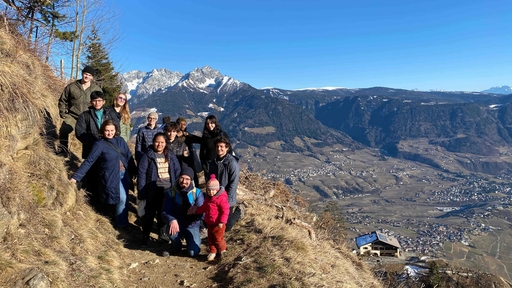A group of Guilford College students stands on a mountain trail in the Italian Alps.