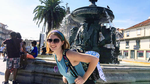 Amber Dumont poses for a photo in front of a fountain in Spain.