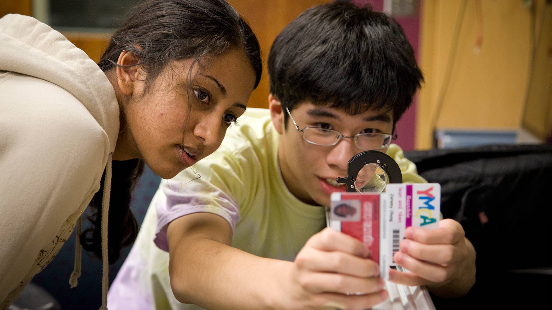 Students try out a Physics experiment using their ID cards.