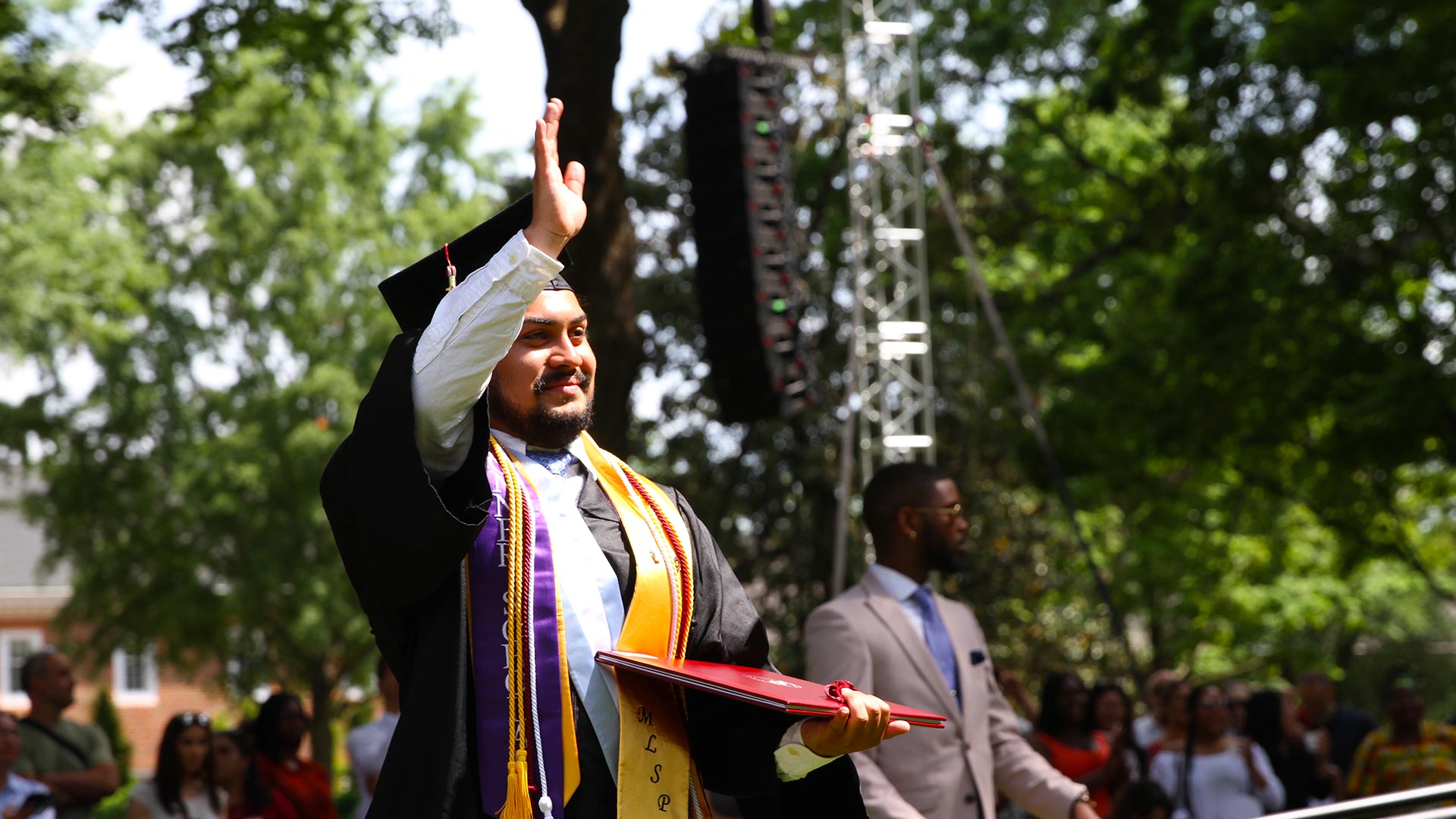 A student celebrates after receiving their diploma.