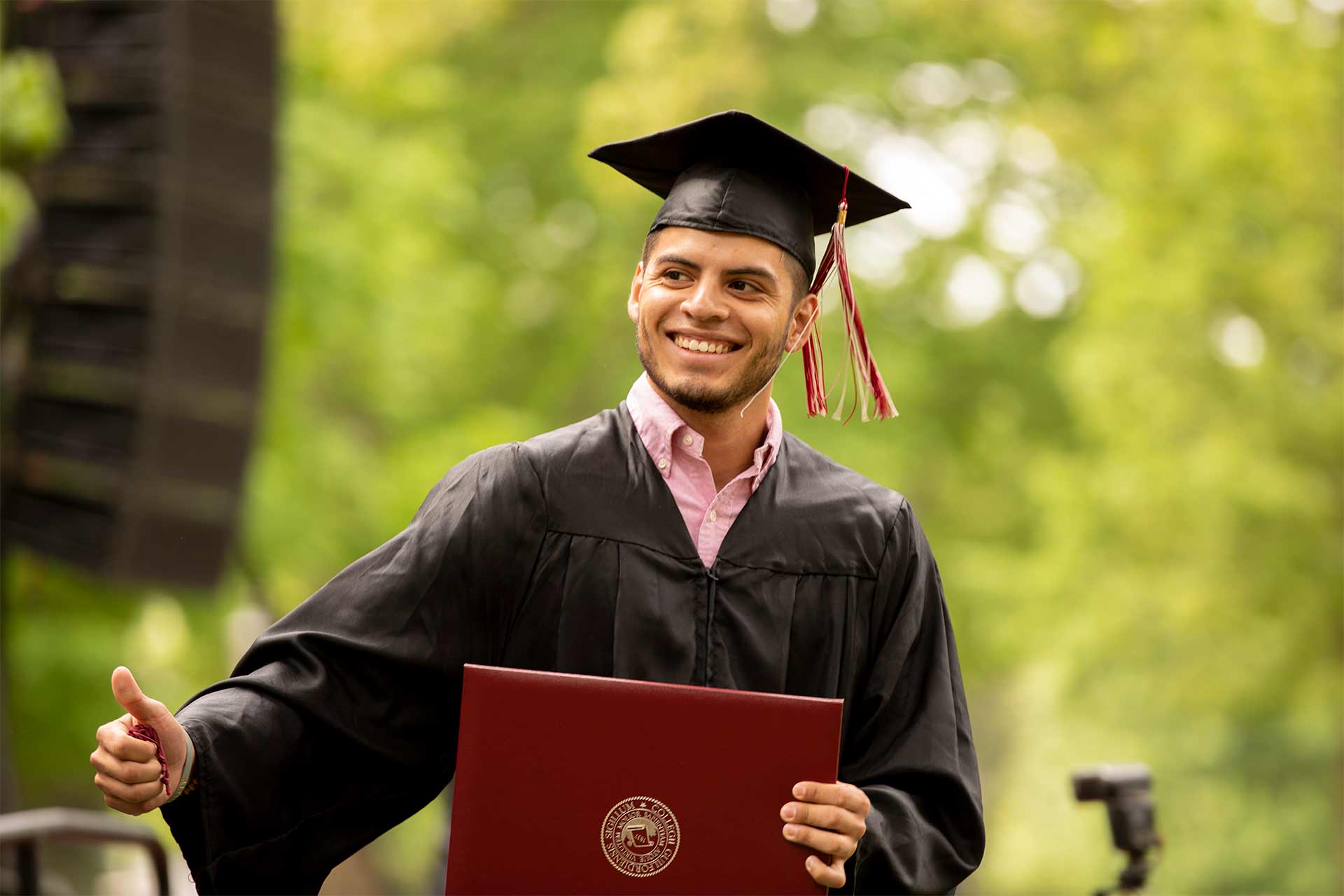 A student receives a diploma at Commencement.