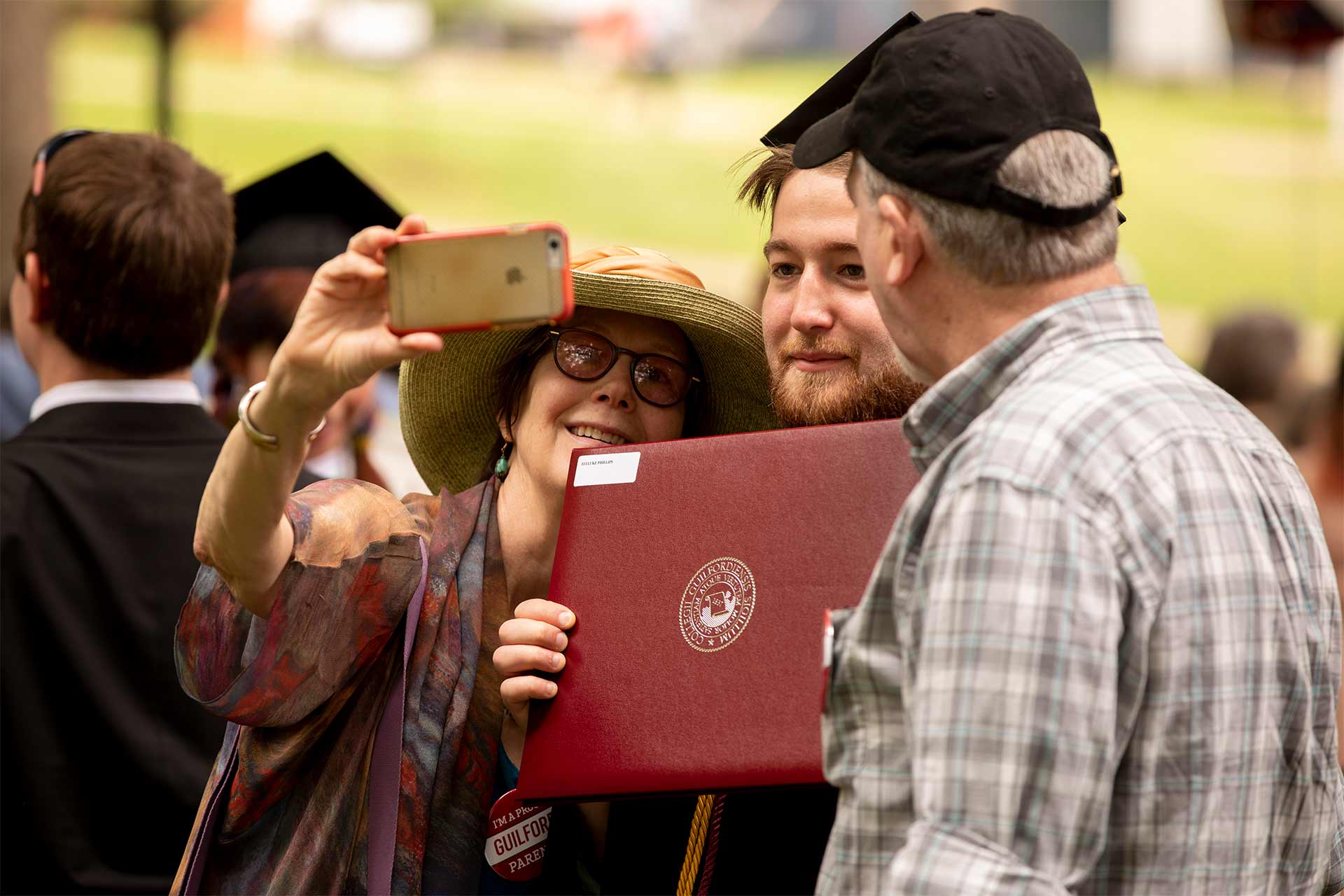 Family and friends take a photo with a student after Commencement.