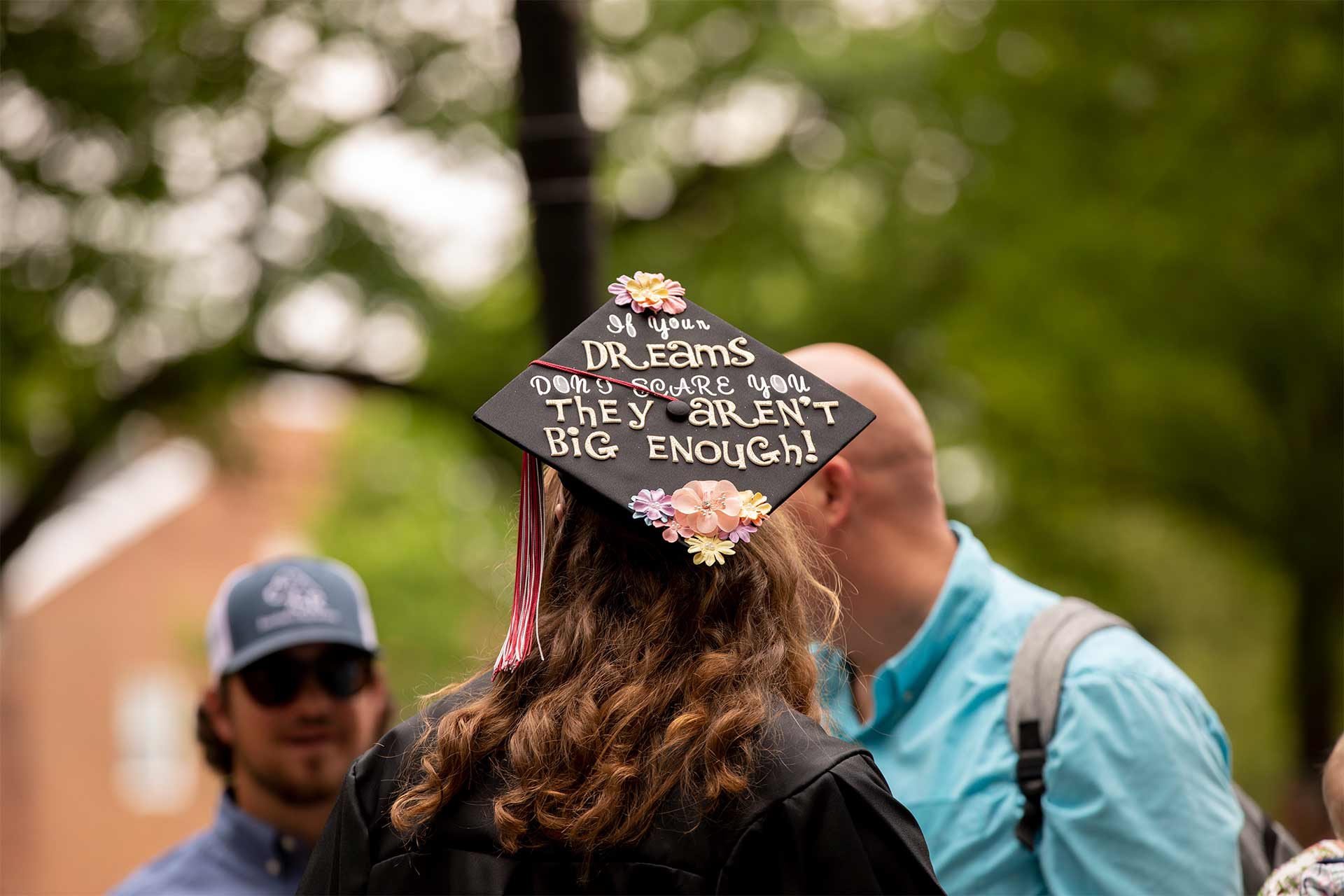 A student's mortarboard reads, "If your dreams don't scare you they aren't big enough!"