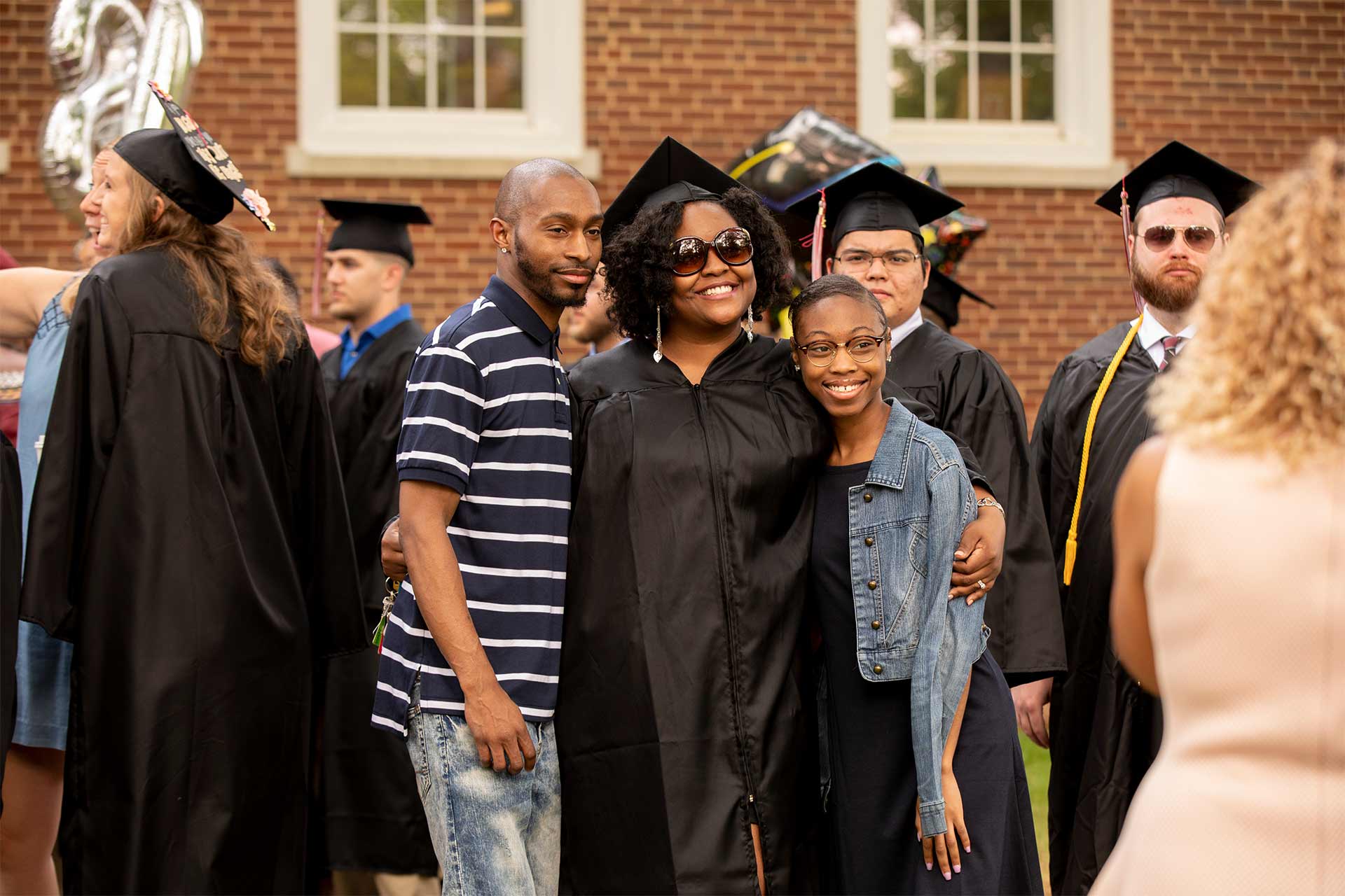 A family takes a photo after Commencement.