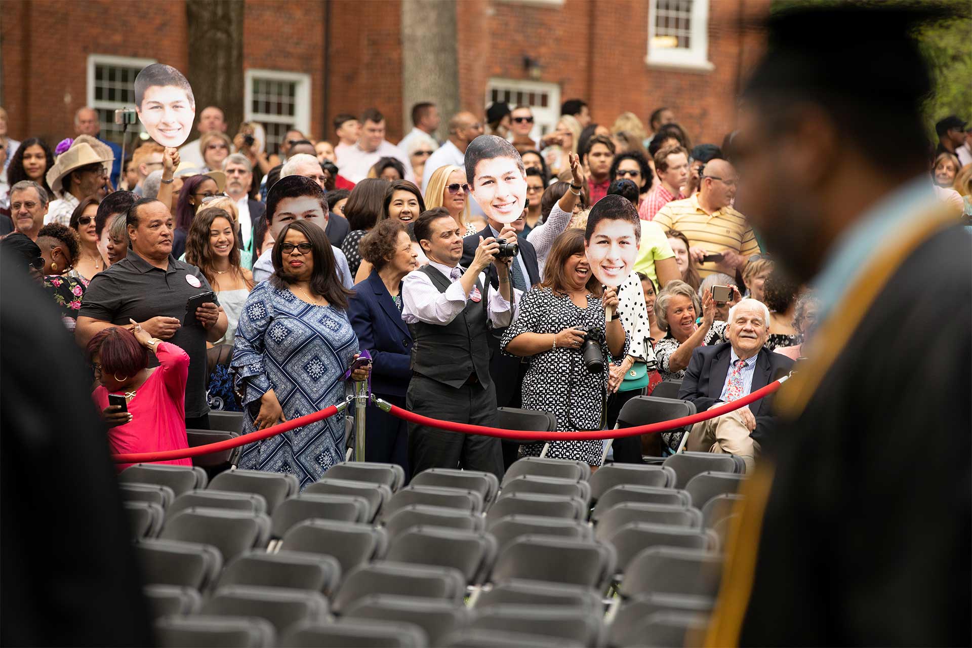 Family and friends cheer on their graduates as students are welcomed to Commencement.