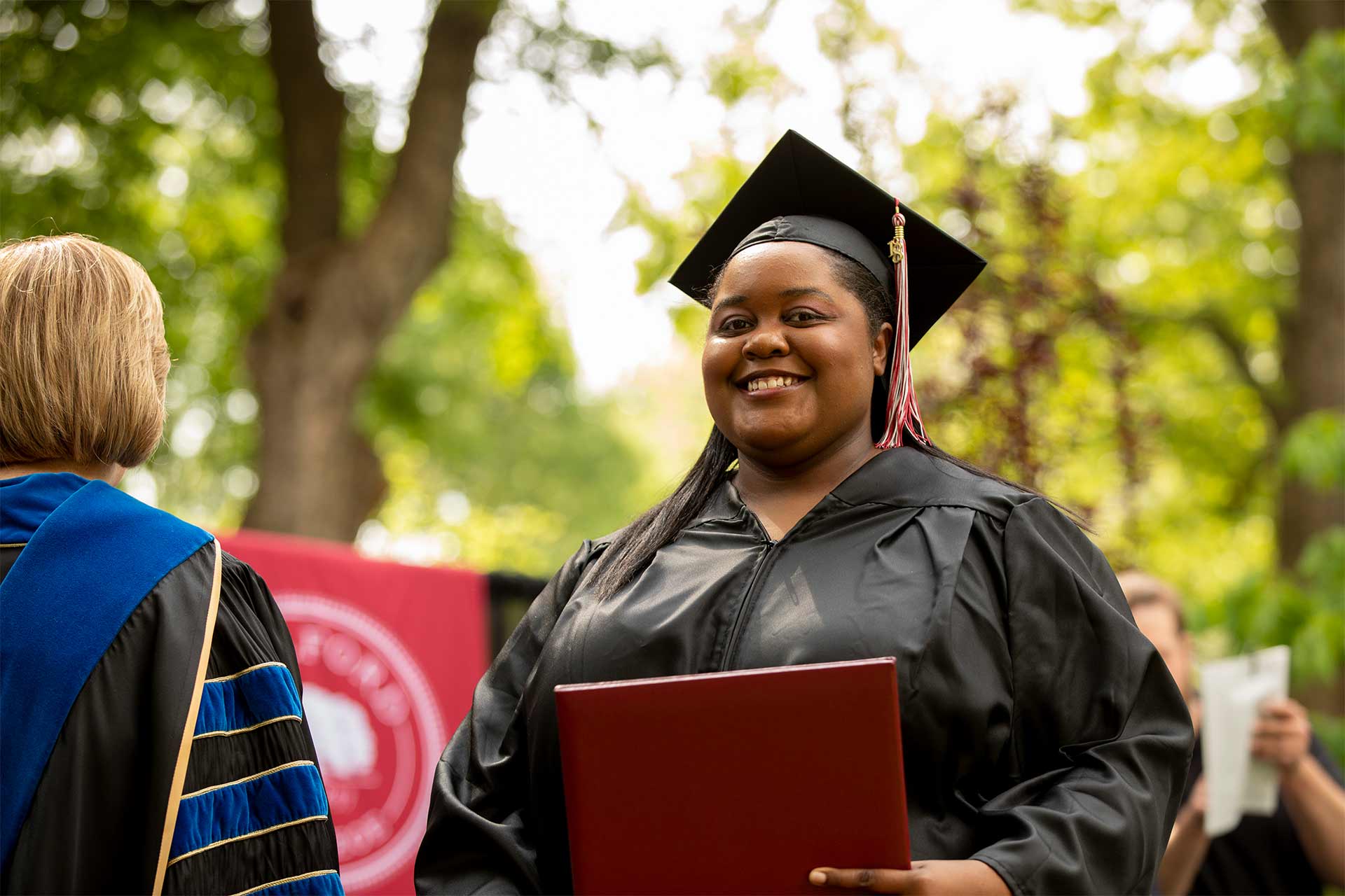 A student receives a diploma at Commencement.