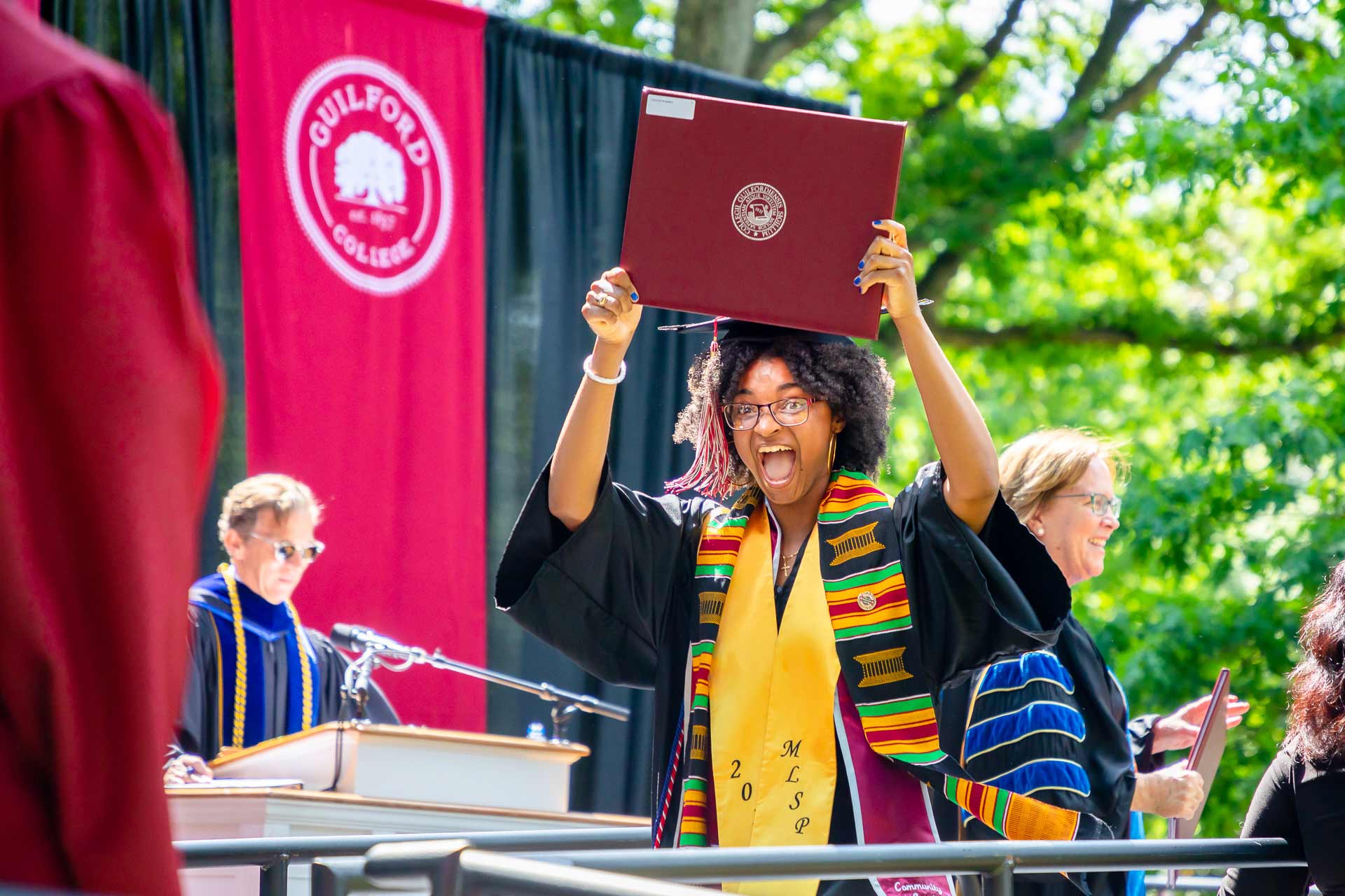 A student celebrates after receiving their diploma.