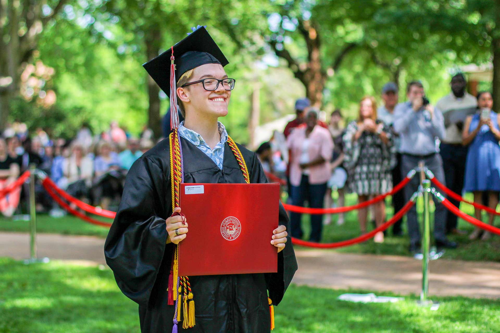 A student celebrates after receiving their diploma.