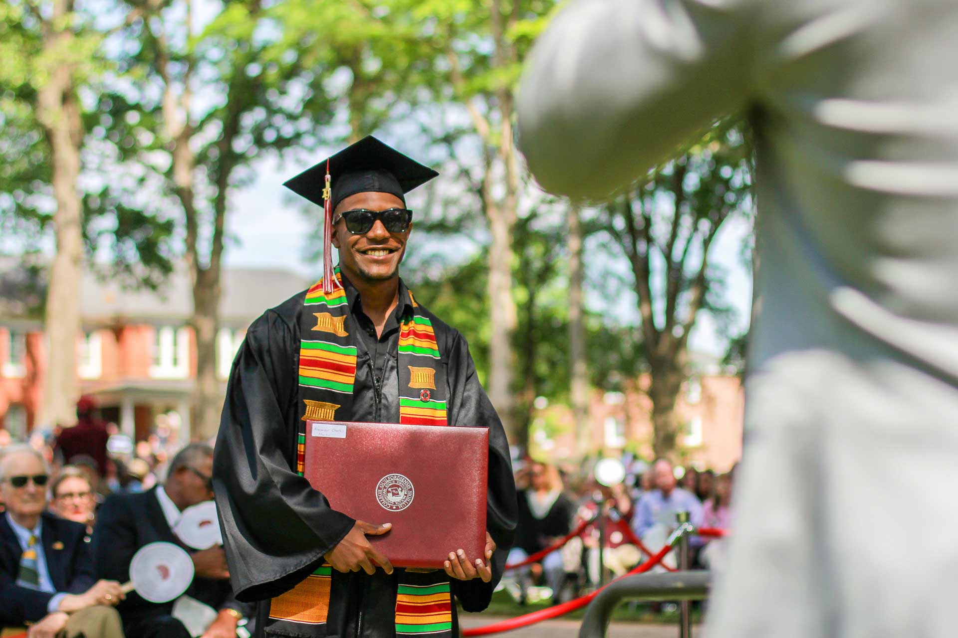 A student celebrates after receiving their diploma.