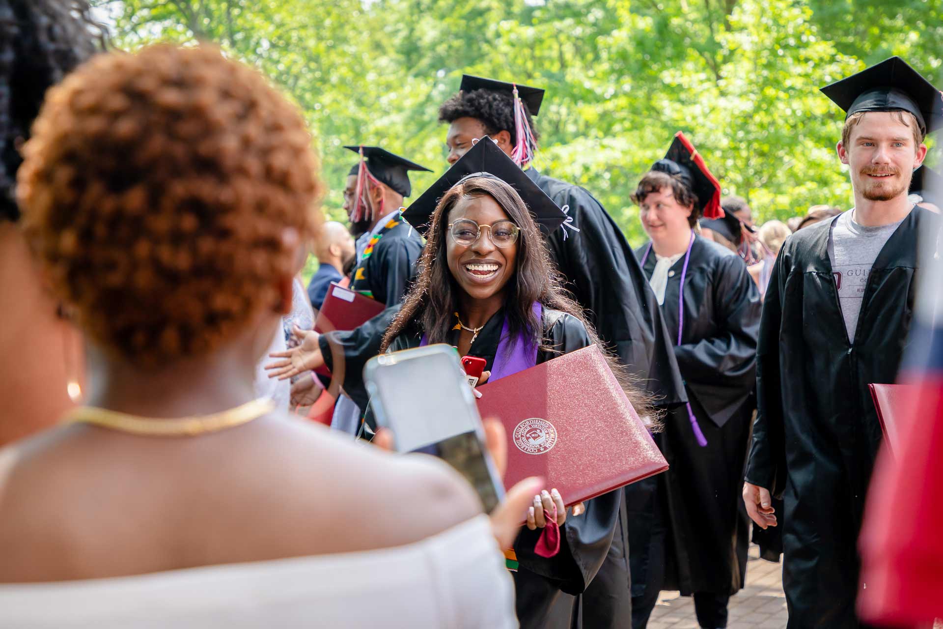 A student celebrates after receiving their diploma.