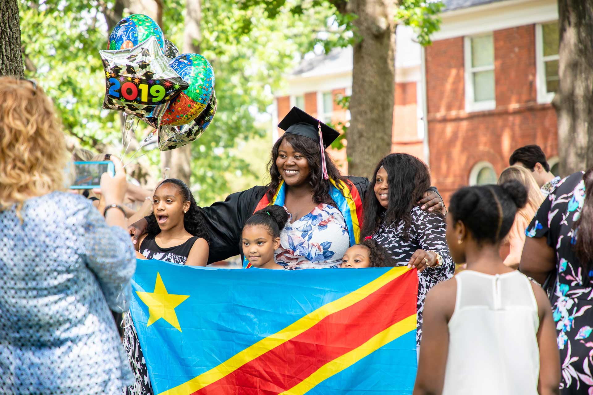 A student celebrates with friends and family after Commencement.