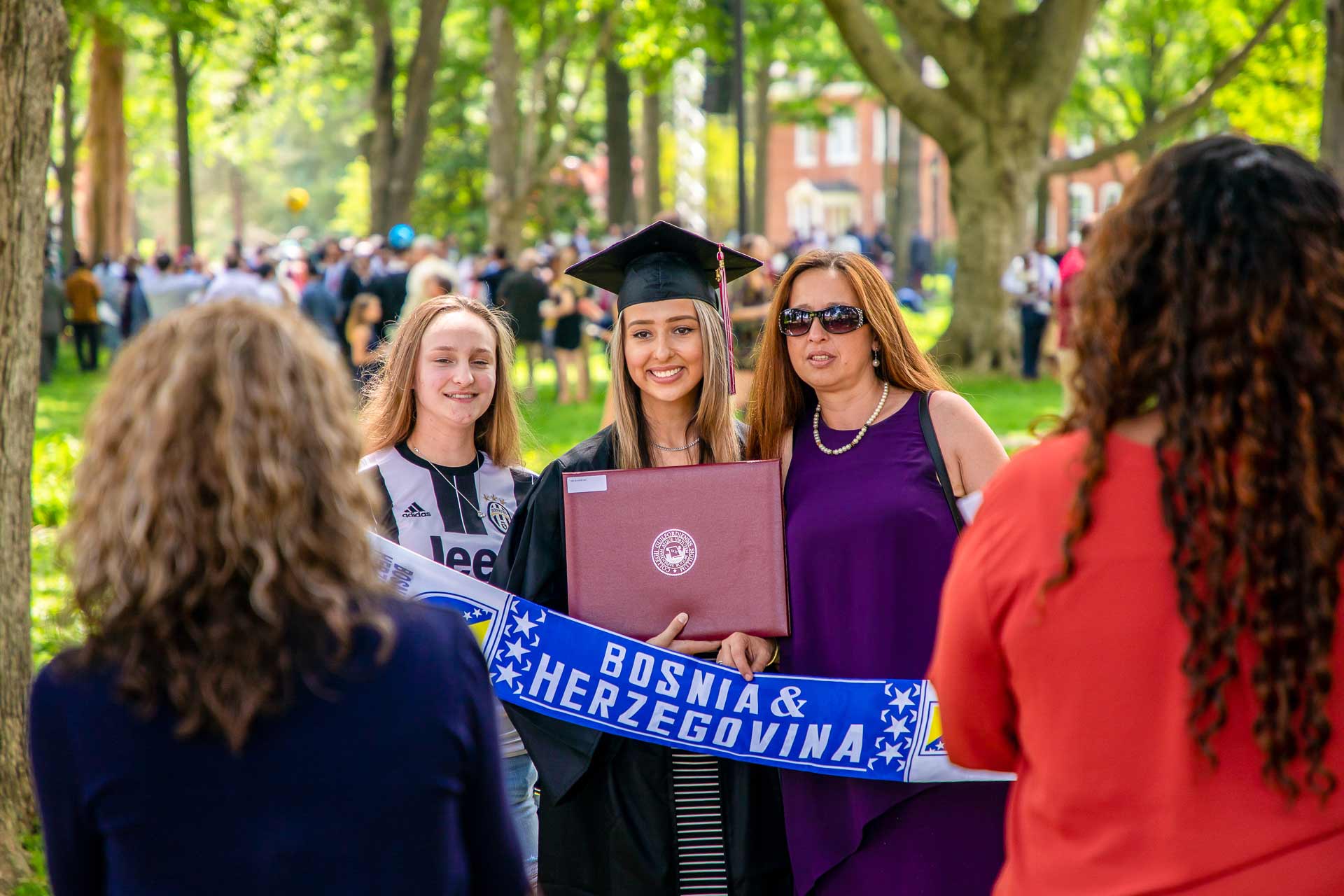 A graduate celebrates with family and friends after Commencement.