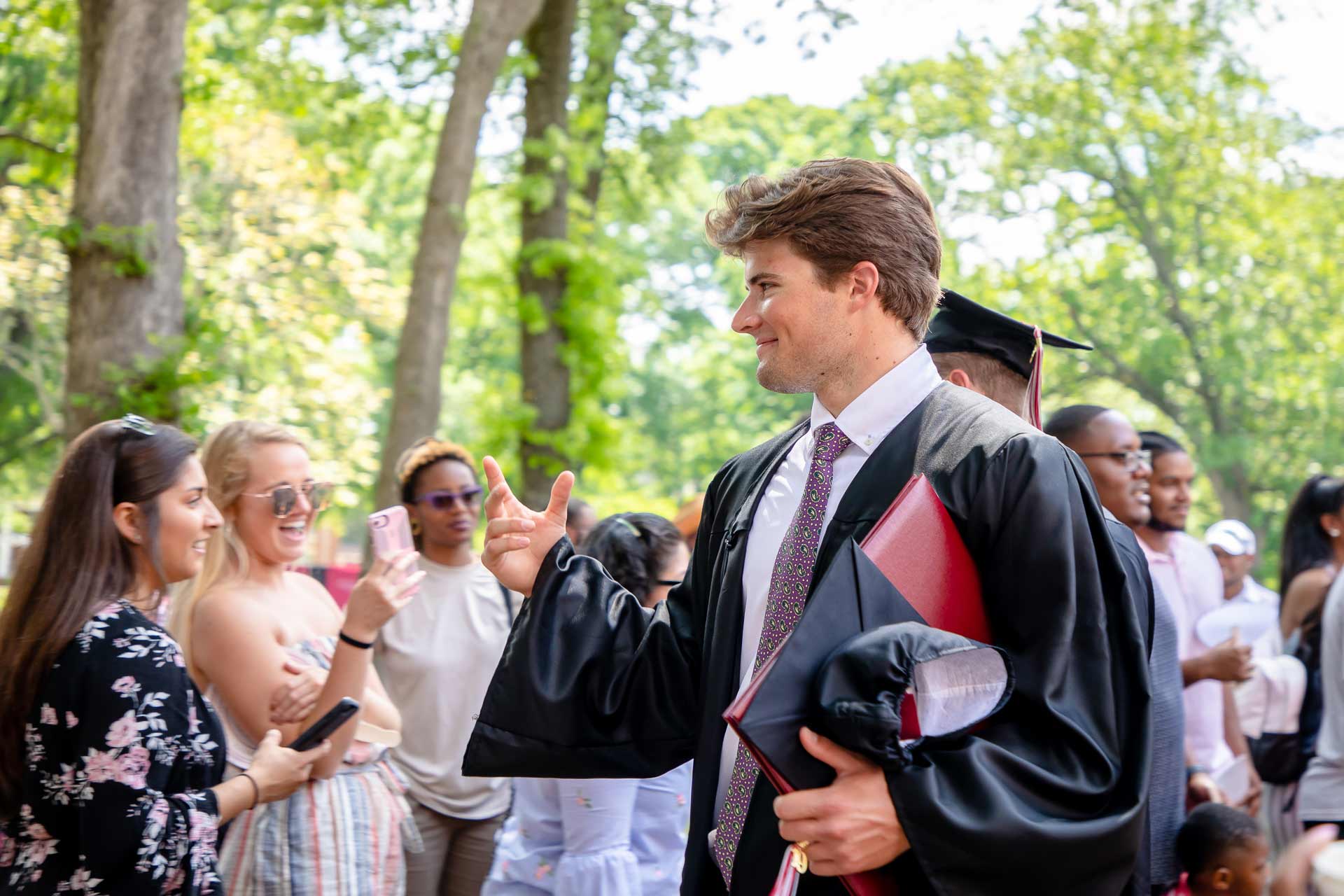 A student celebrates after Commencement.