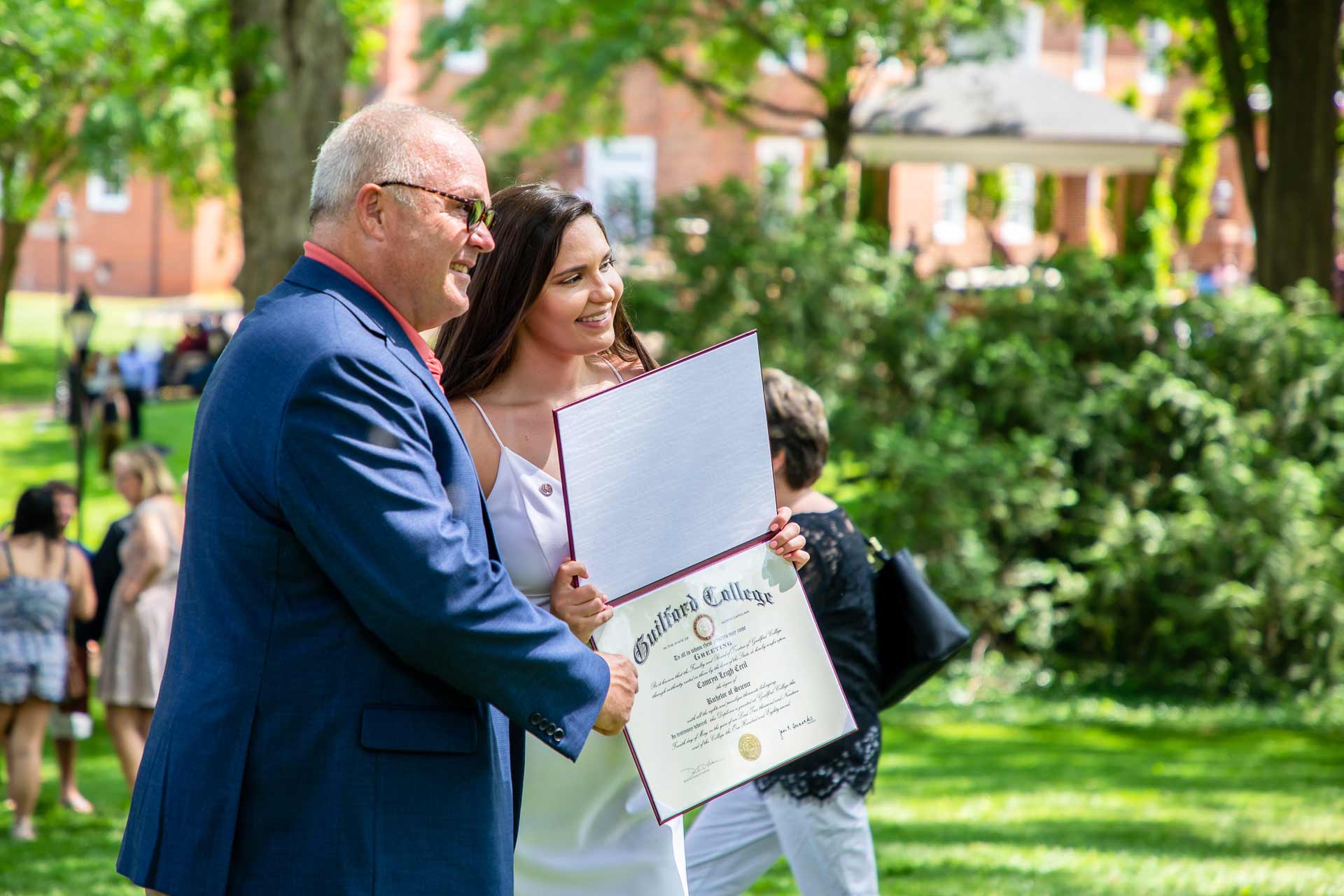 A student celebrates with friends and family after Commencement.