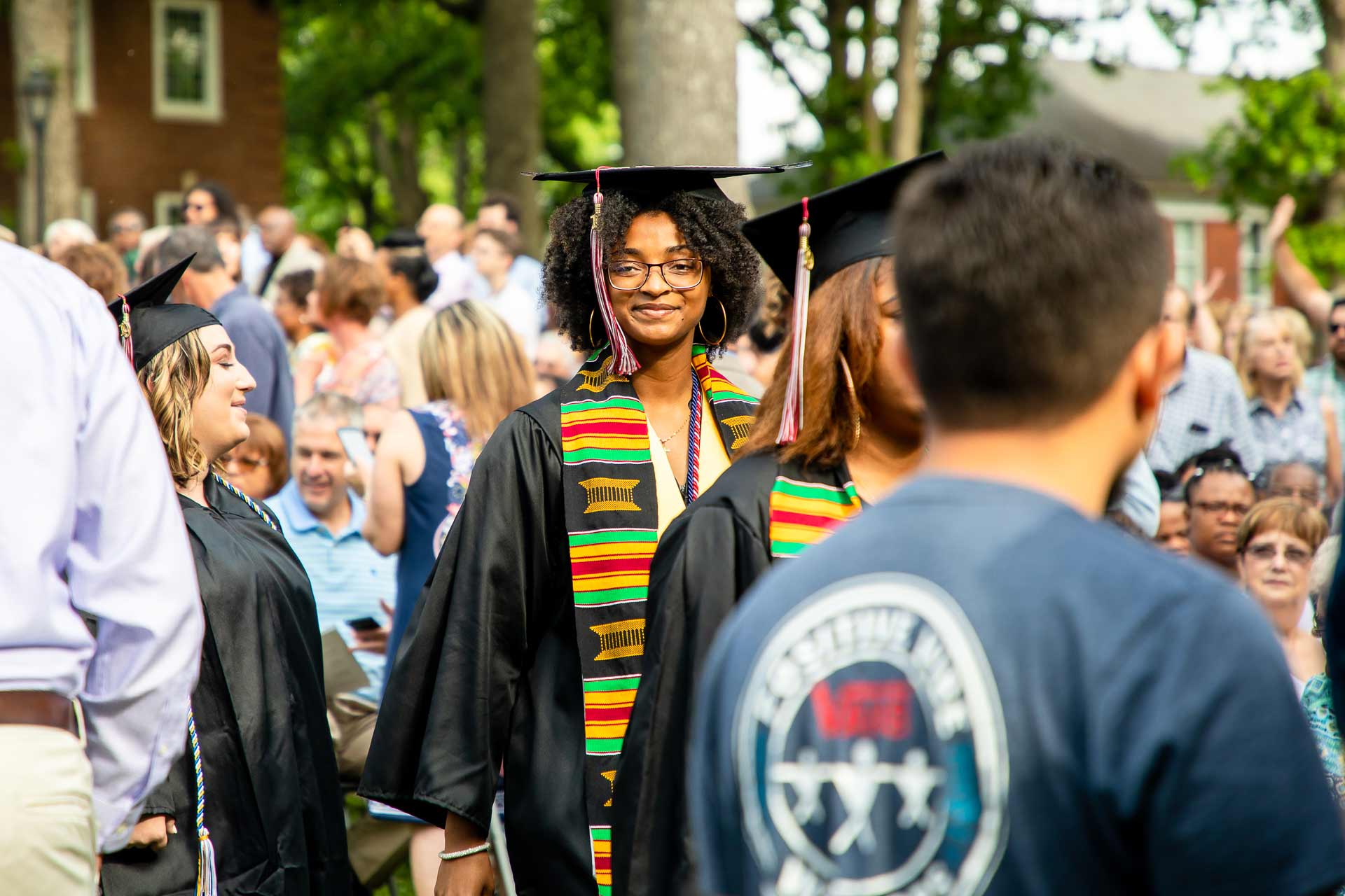 Graduating students walk to Commencement.