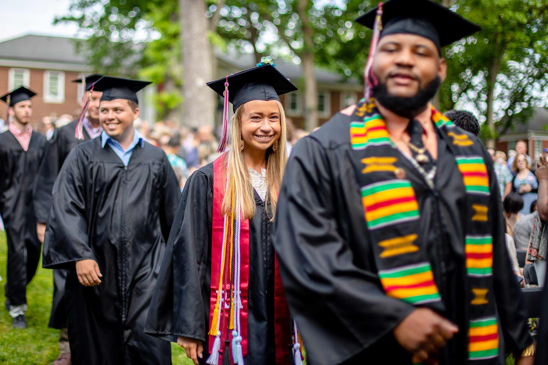 Graduating students walk to Commencement.