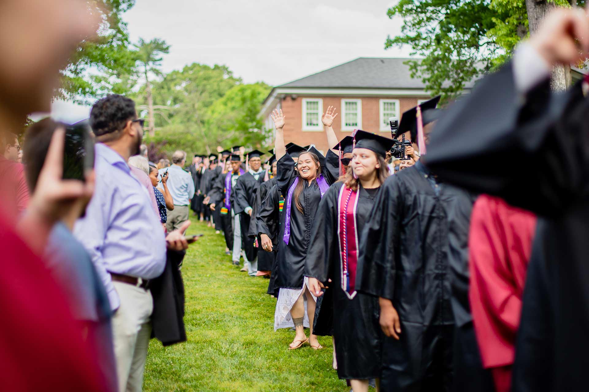 Graduating students walk to Commencement.