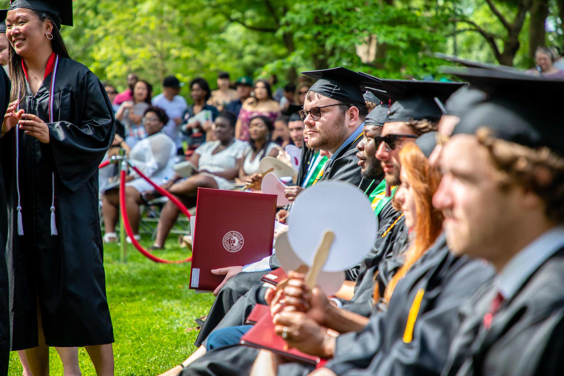 Graduating students sit at Commencement.