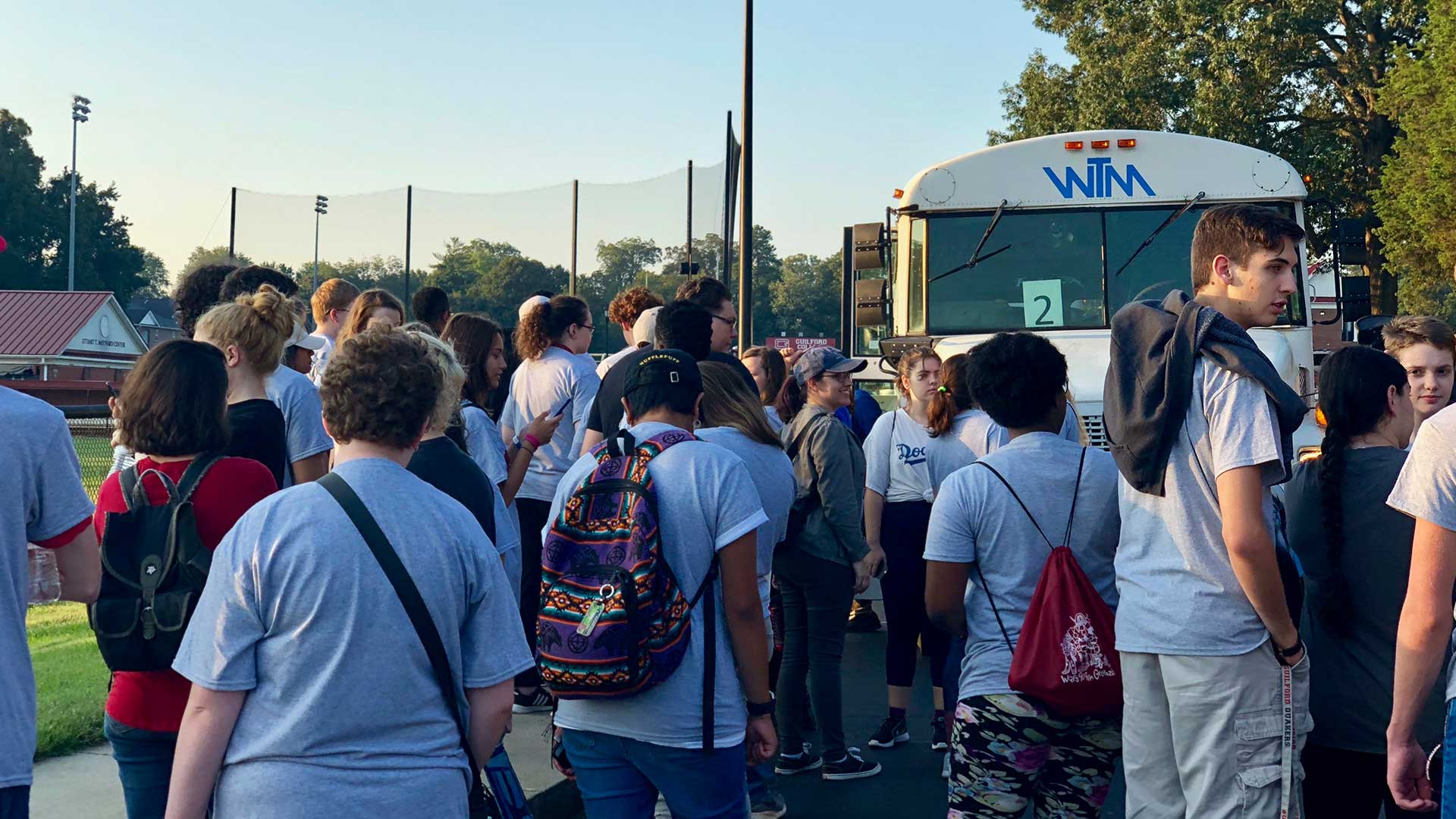 Student volunteers head to the buses that take them to work sites on Day of Service.