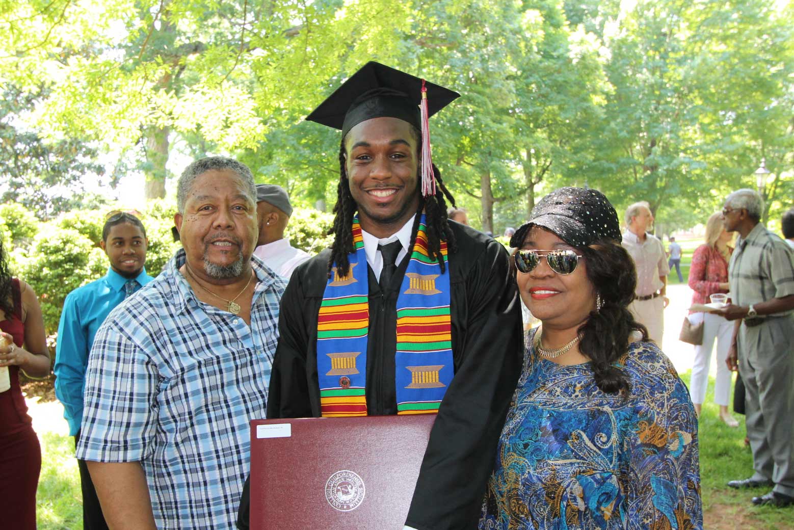 Proud parents take a photo with their graduate.