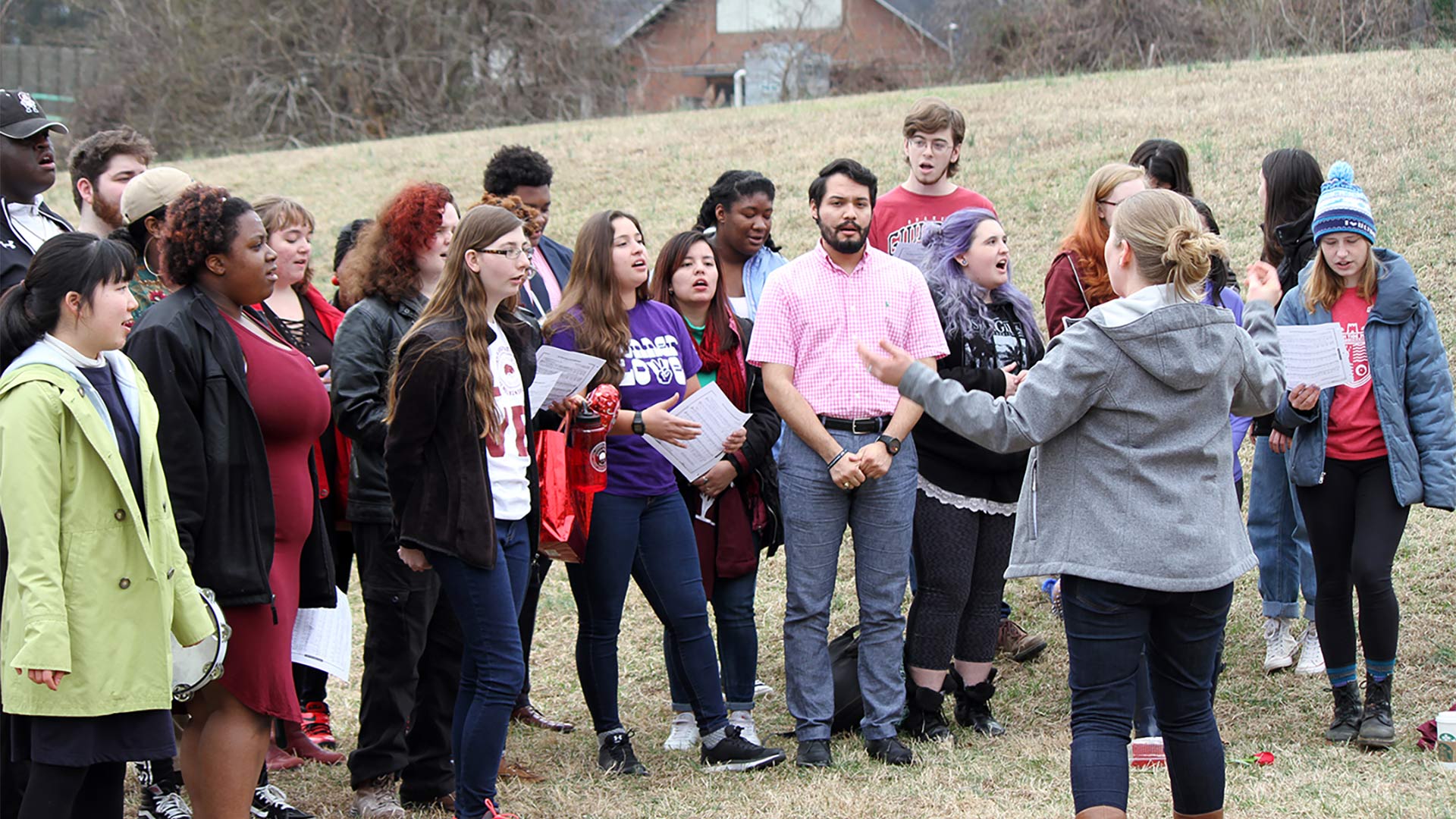 Guilford's LUMINA Treble Ensemble and members of the Guilford College Choir, led by Associate Professor of Music Wendy Looker, led the crowd in a song, performed as a round, inspired by the Beatles.