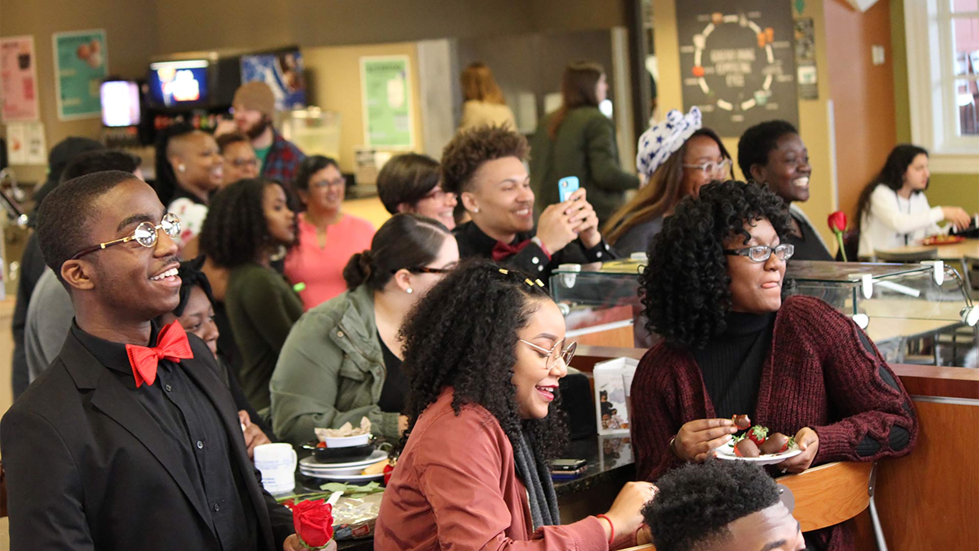Students watch the rap battle in the dining hall.
