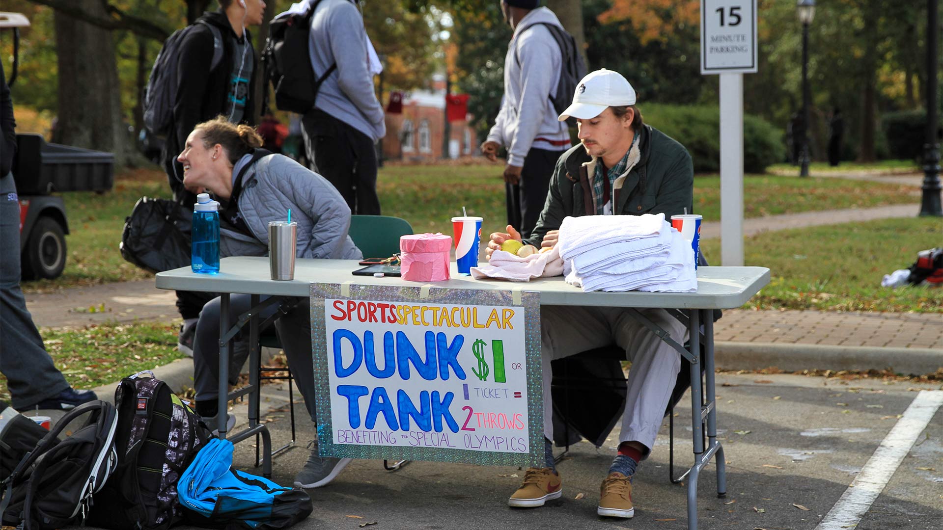 Students take donations for the dunk tank at the fall Sports Spectacular event.