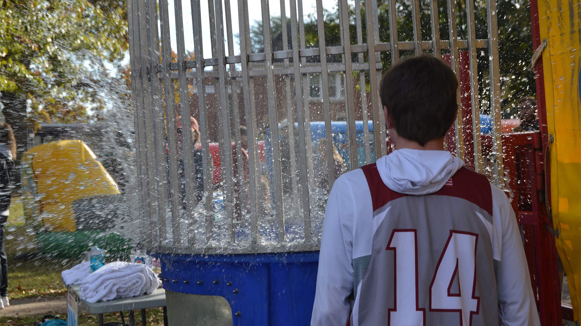 A participant takes a dip in the dunk tank during Sports Spectacular.