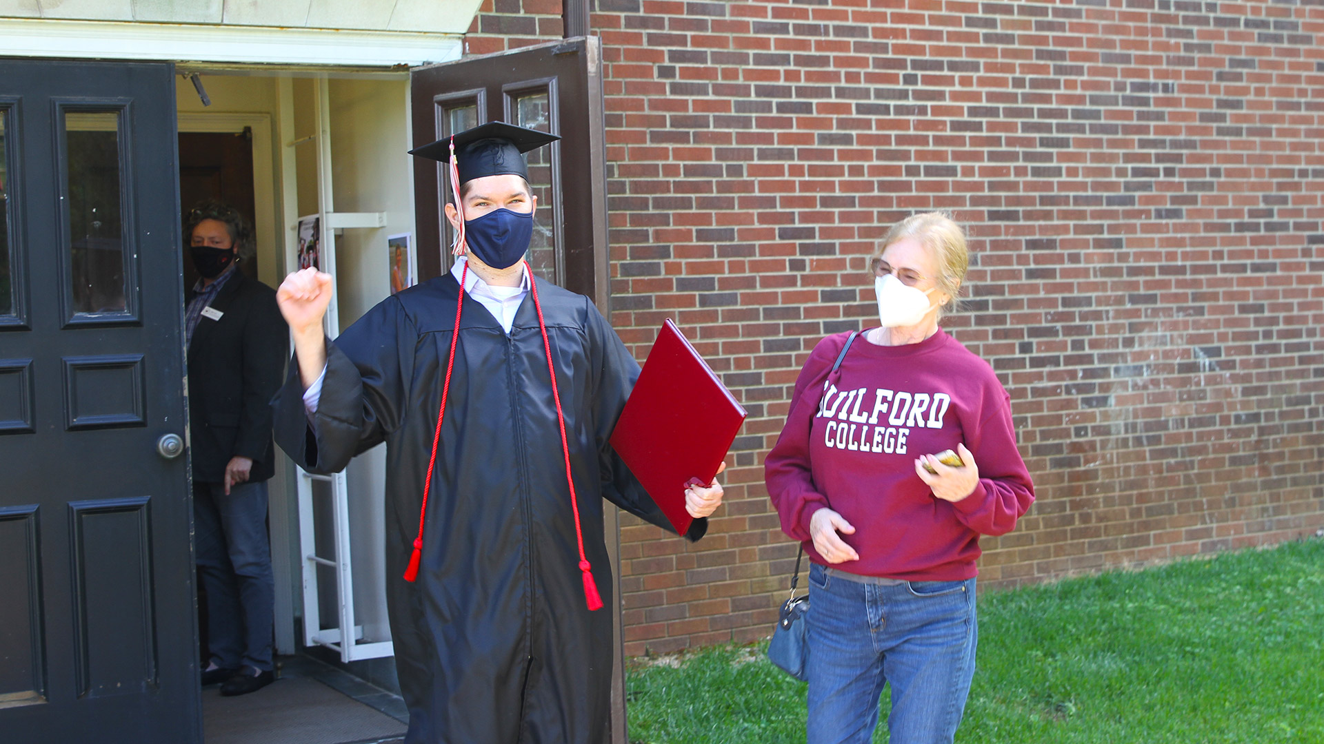 A student celebrates outside after Commence 2020.
