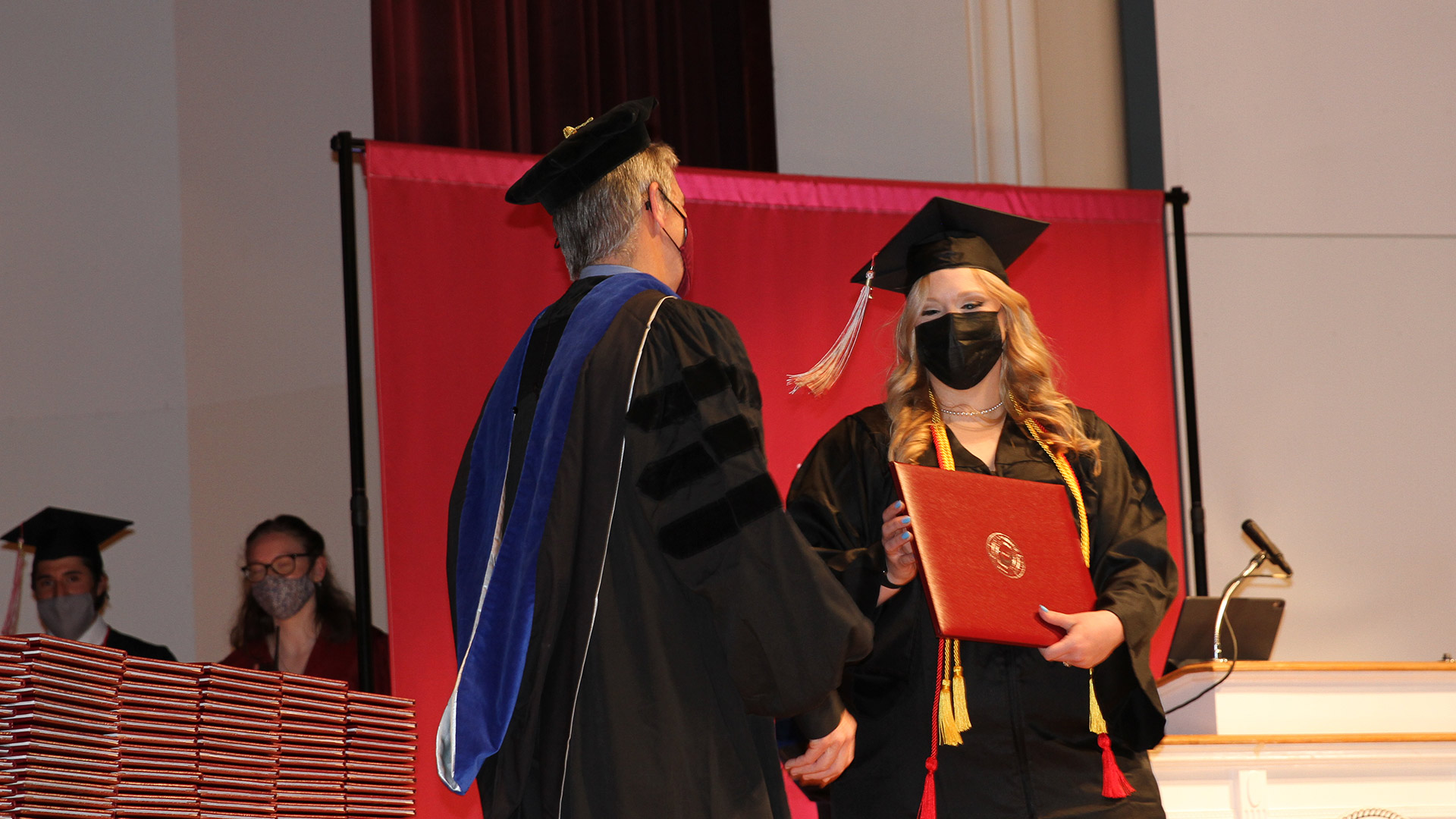 Interim President Jim Hood '79 greets a graduate from the Class of 2020.