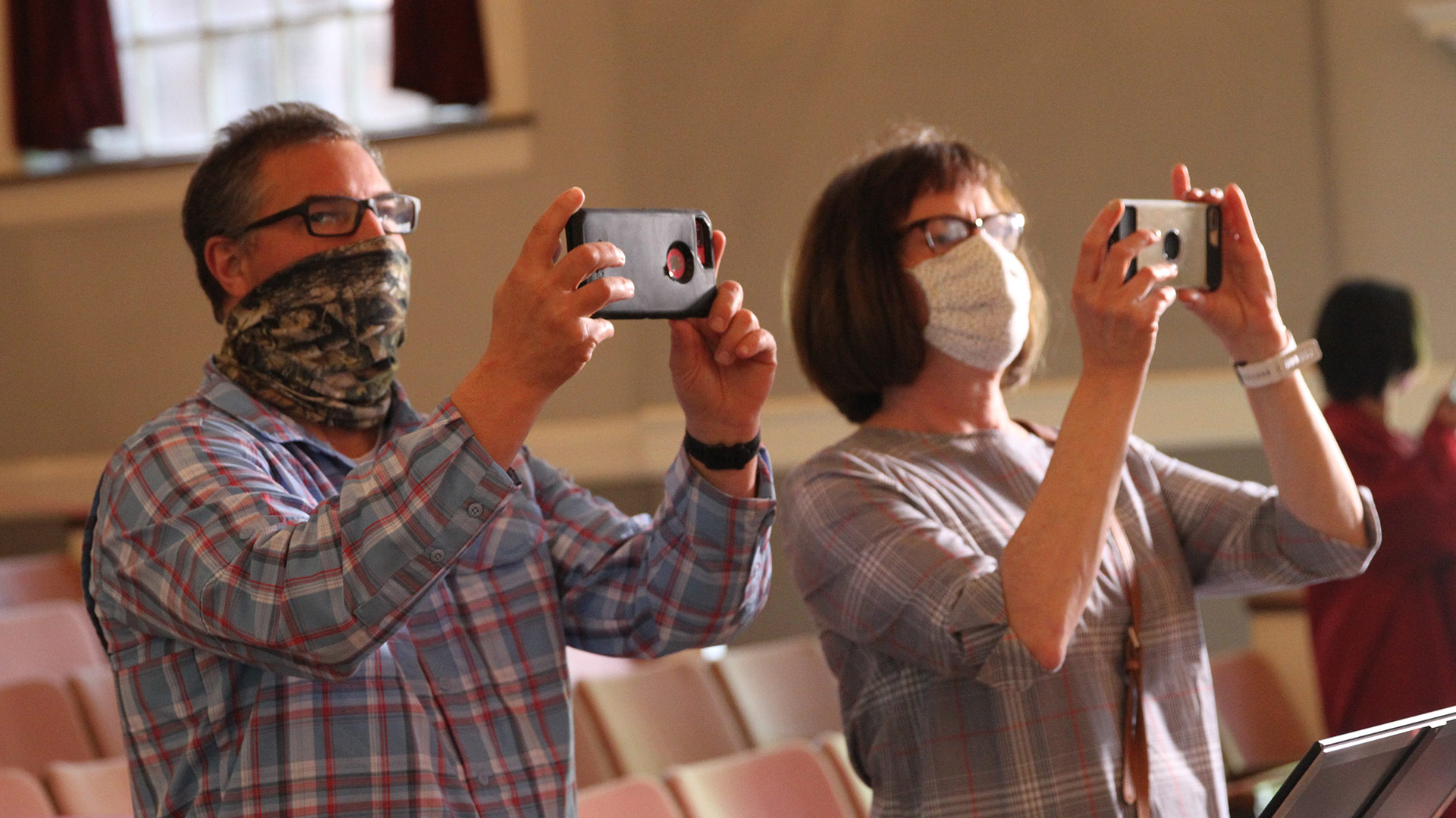 Due to COVID restrictions, individual family celebrations, in sequence, continued for about three hours. In this photo, family members take photos in Dana Auditorium.