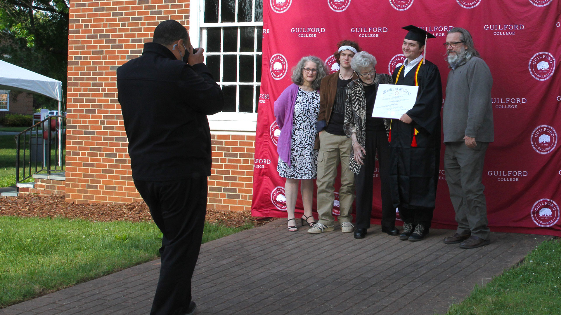 Many graduates posed with their families in front of the Guilford backdrop.