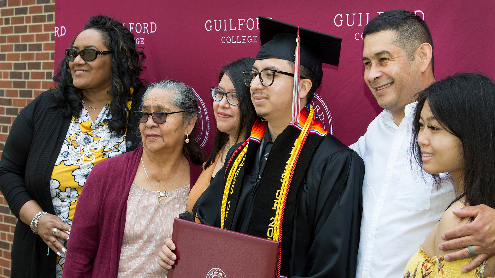 A family takes a photo together at Commencement.