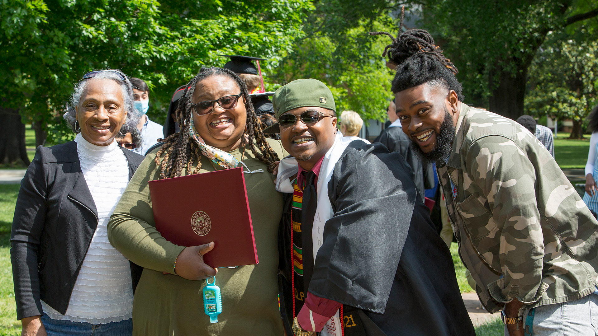 A proud family takes a photo with its graduate.