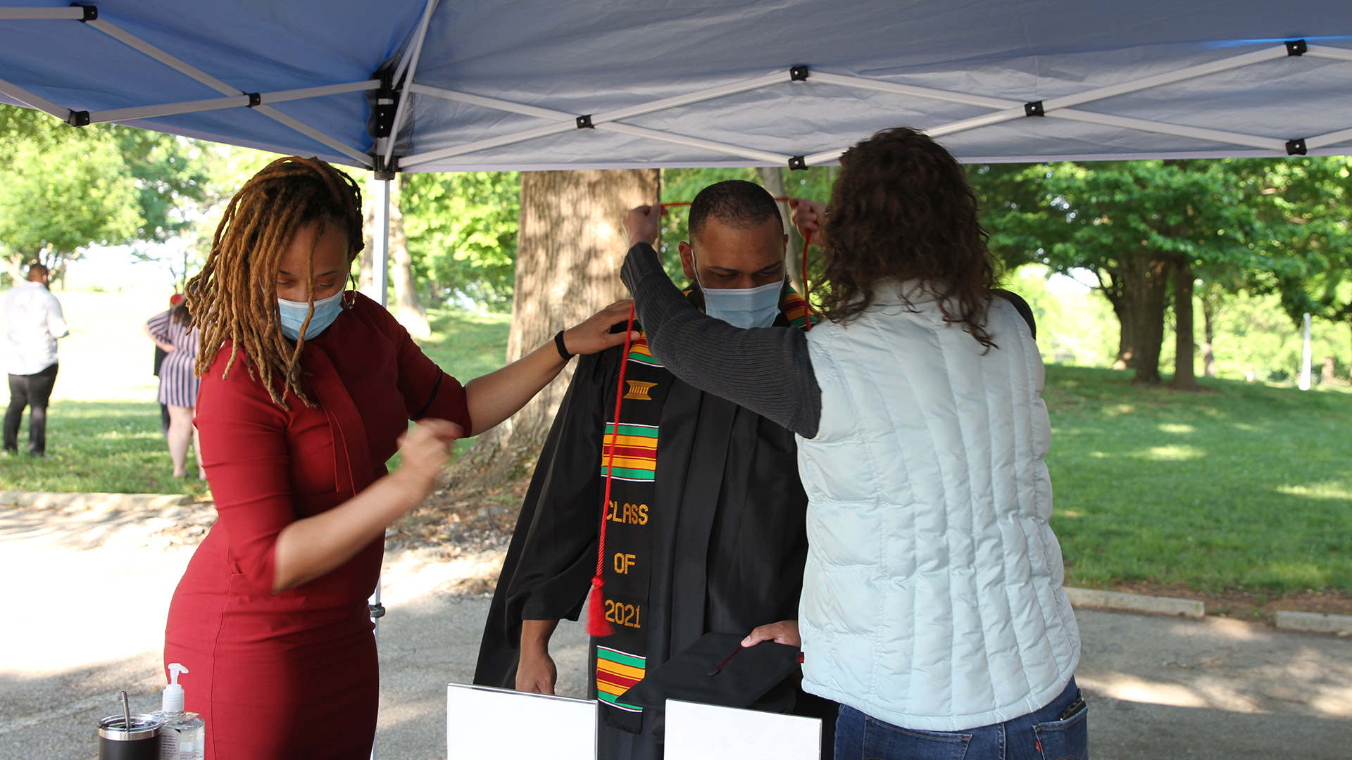 Commencement check-in was a time for checking stoles, cords, and ribbons.