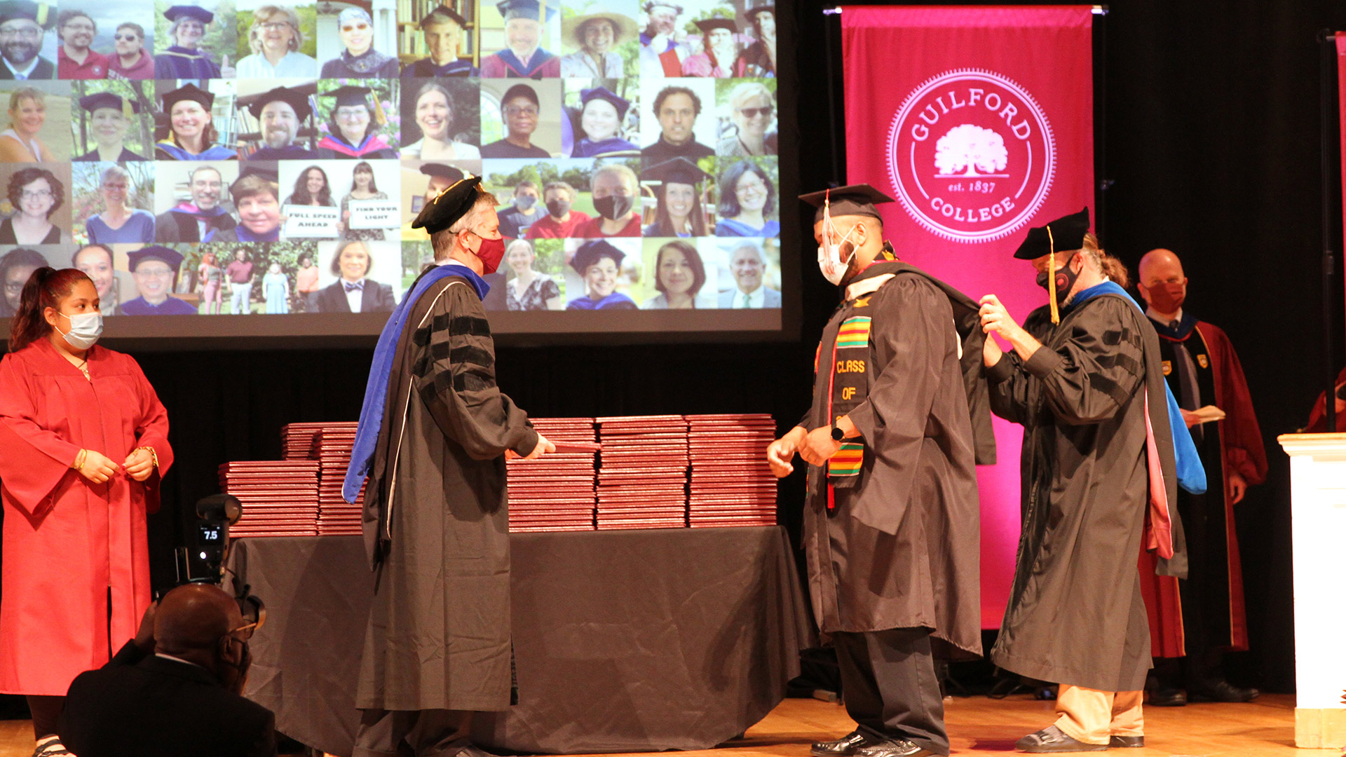 A hooding ceremony takes place for a graduate with a Master's Degree in Criminal Justice.