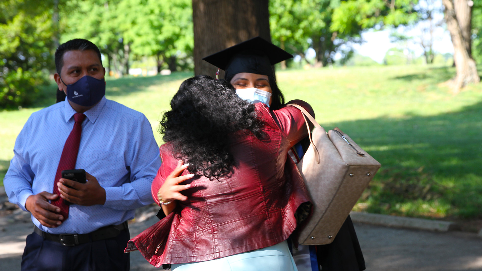 A student gives out hugs at Commencement 2021.