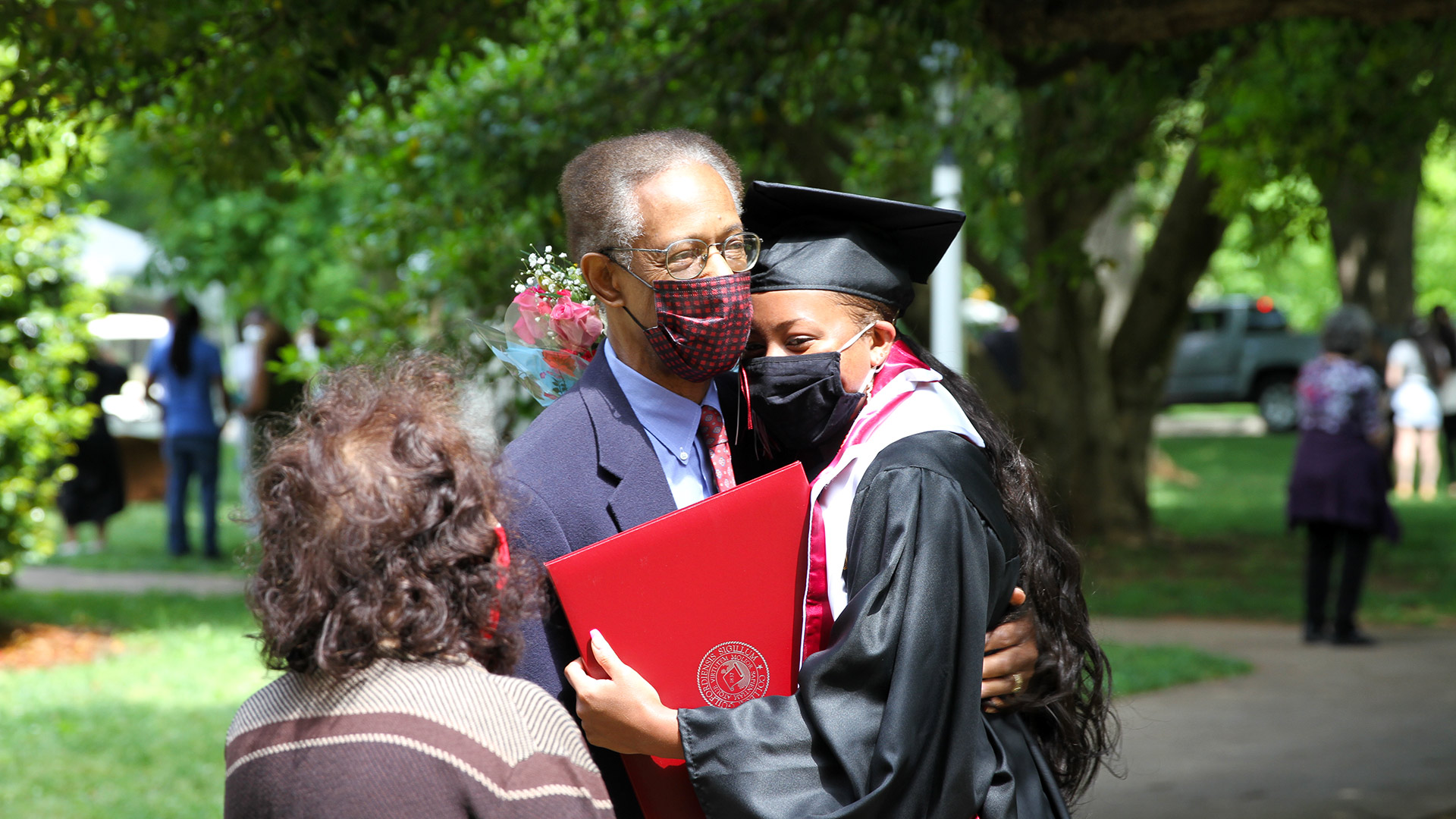 A student embraces a family member after Commencement.