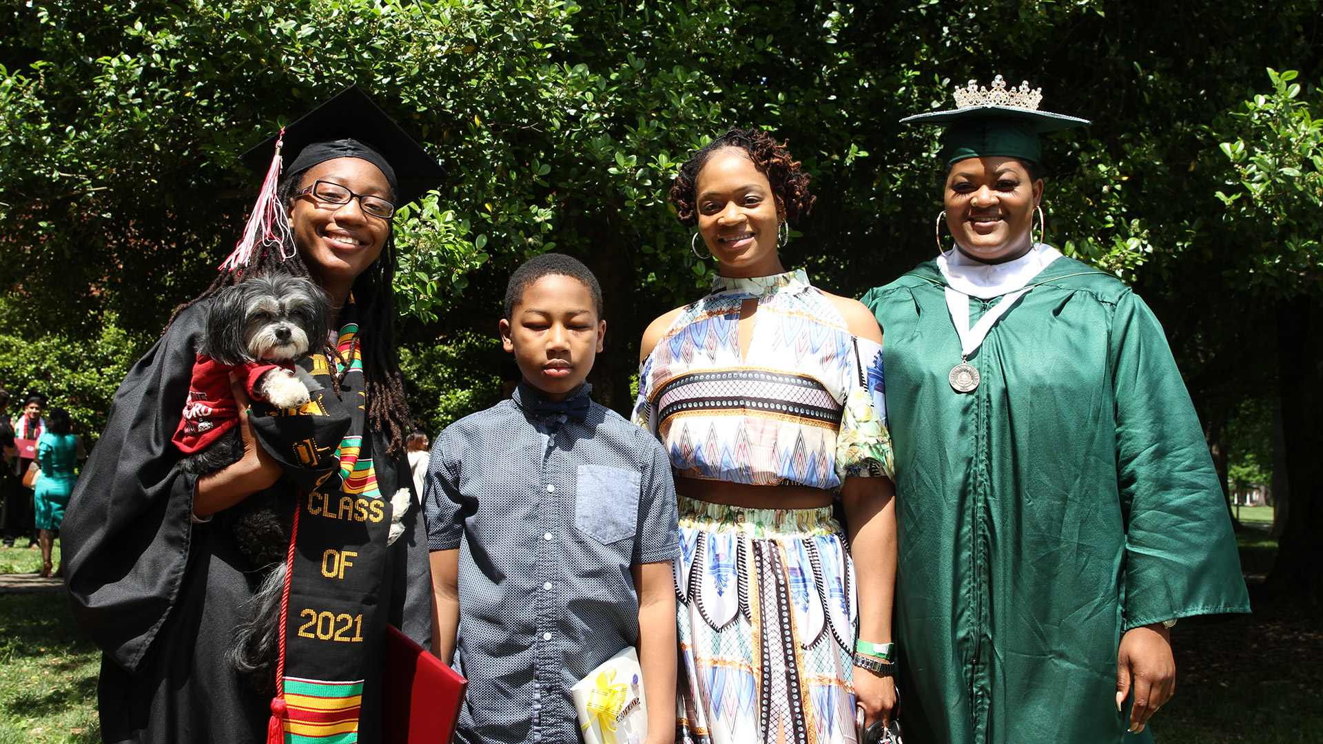 A family takes a photo with a 2021 graduate after Commencement.