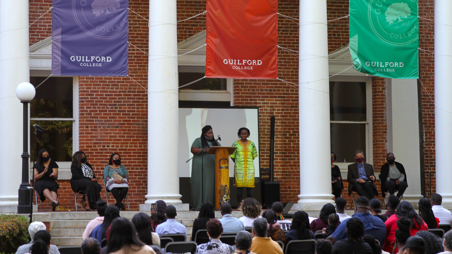 Staff speakers stand before the crowd at the Sankofa celebration on May 6, 2021.