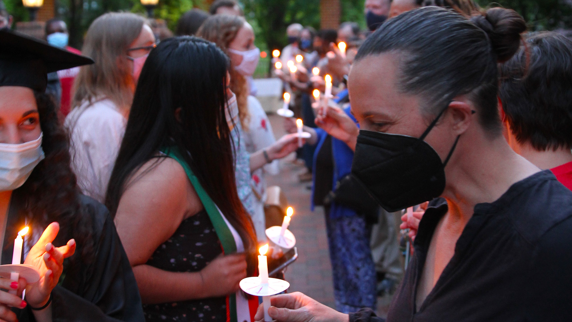 Students light candles at Toast to the Light 2021.