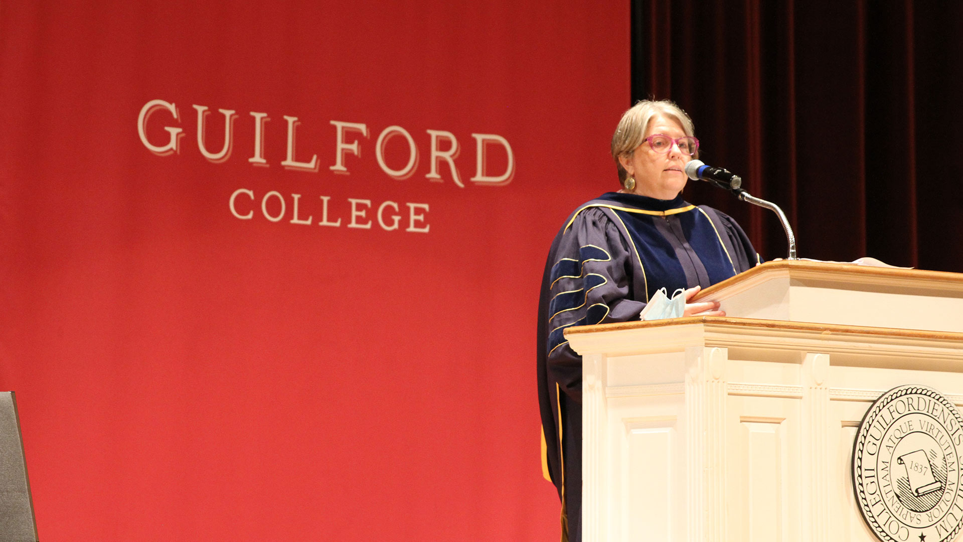 Provost Maria Rosales speaks from the podium.