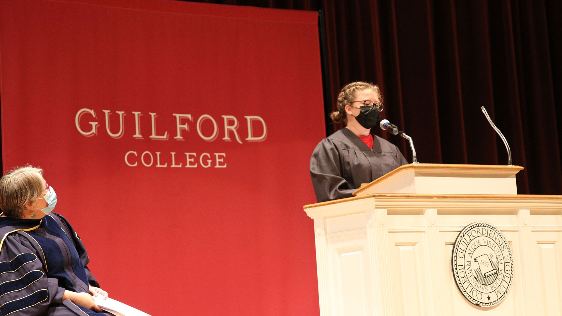 GSBA President Hannah Arnett '21 speaks from the podium.