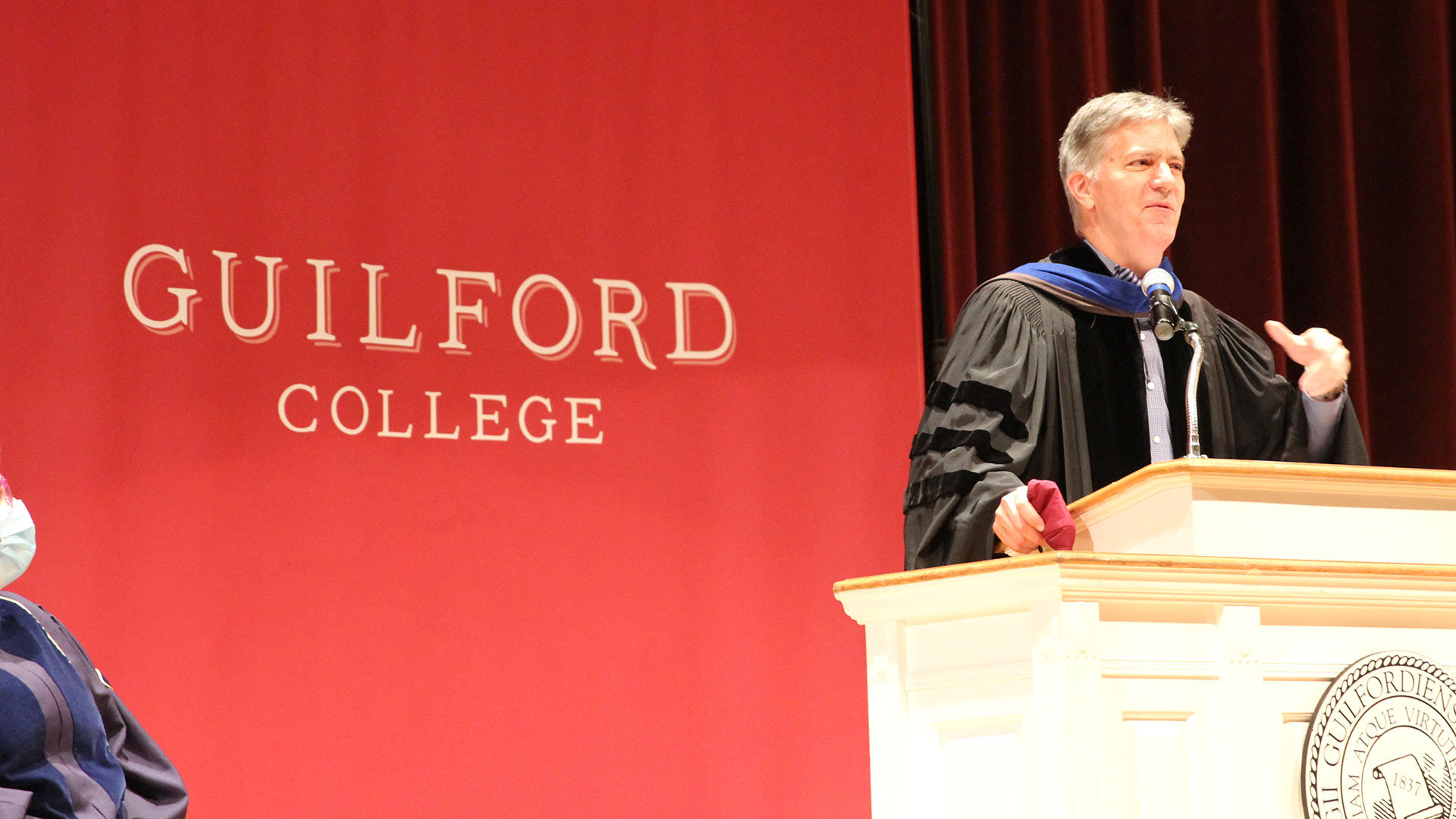 Interim President Jim Hood '79 speaks from the podium.