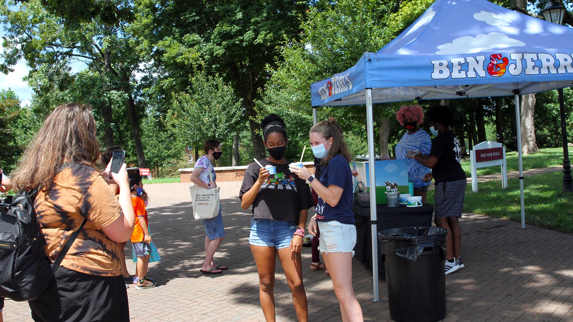 Students take a photo together by the Ben and Jerry's tent on the Quad.