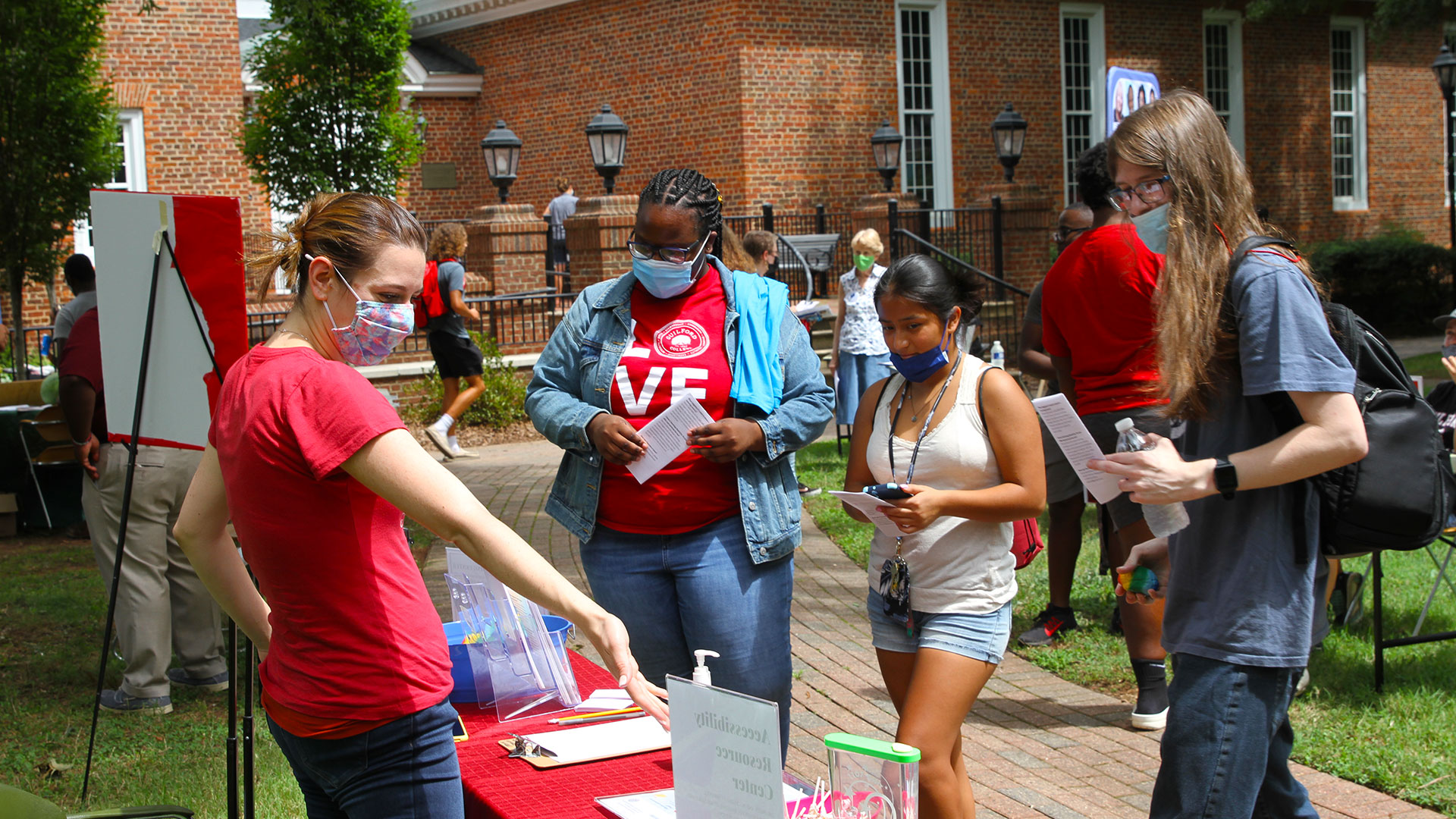 Three students meet a staff member from the Accessibility Resource Center at the Opportunities Fair.