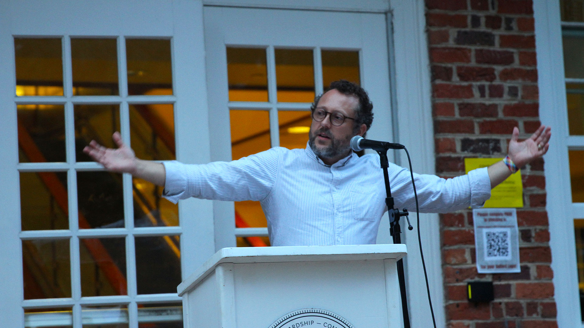 William R. Rogers Director of the Friends Center Wess Daniels speaks at the podium.