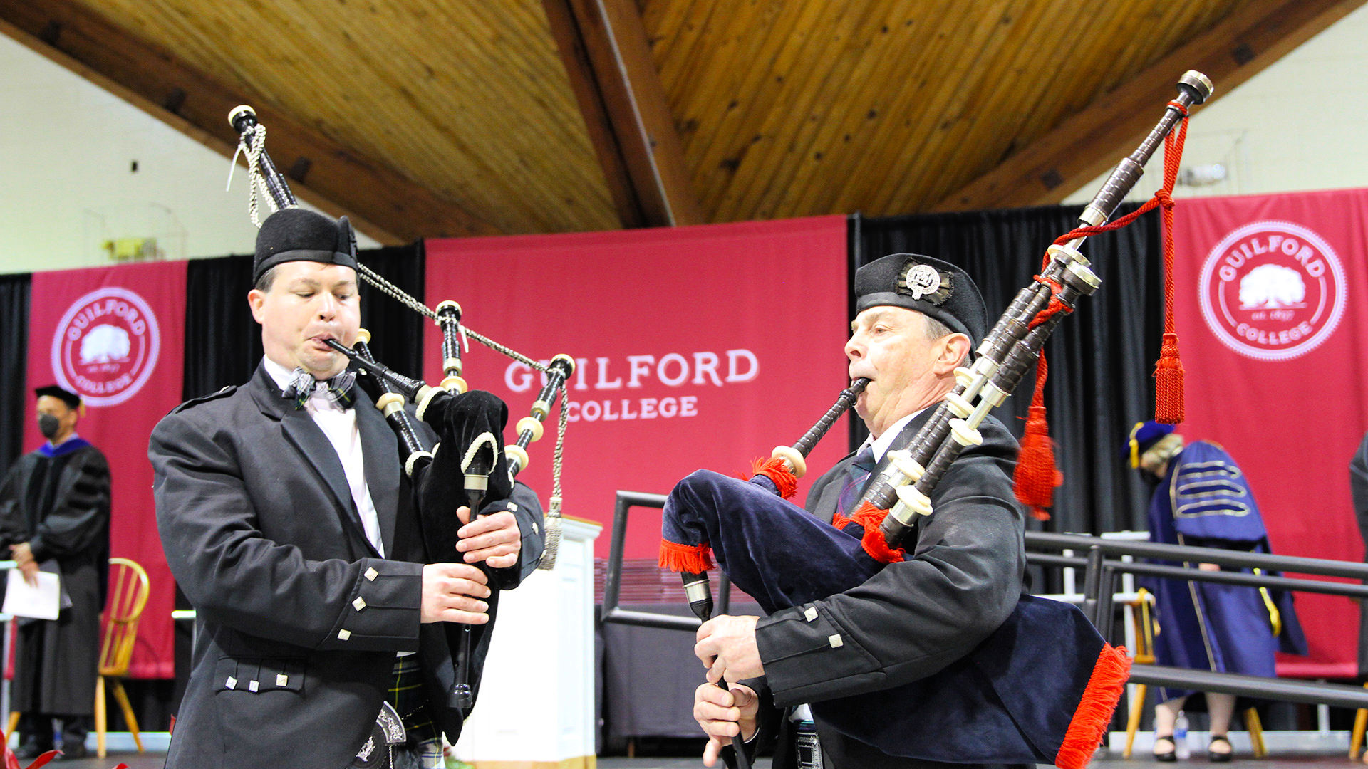 Two bagpipers perform at the start of Commencement.
