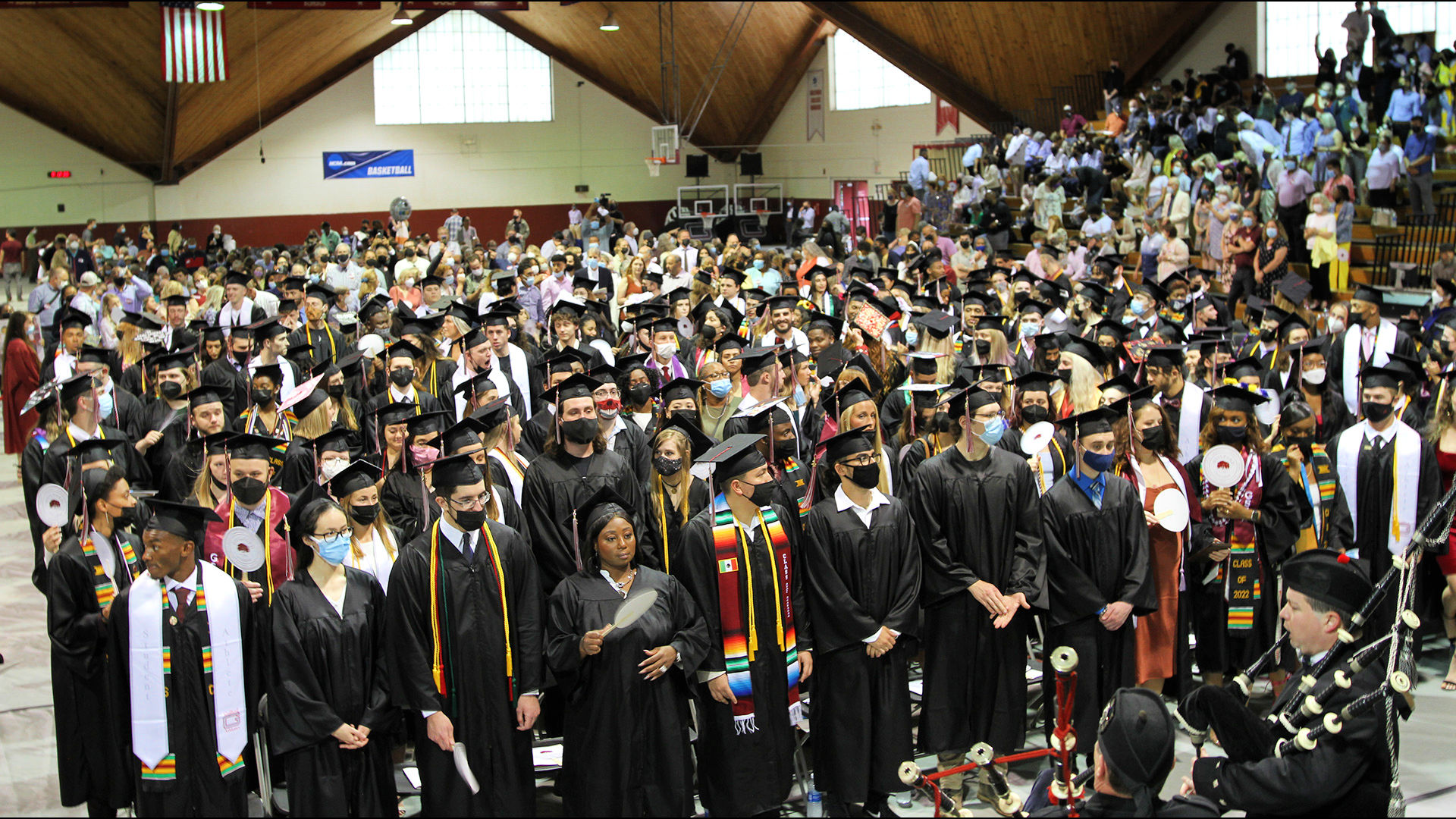 Bagpipers complete their performance as all graduating students fill their seats.