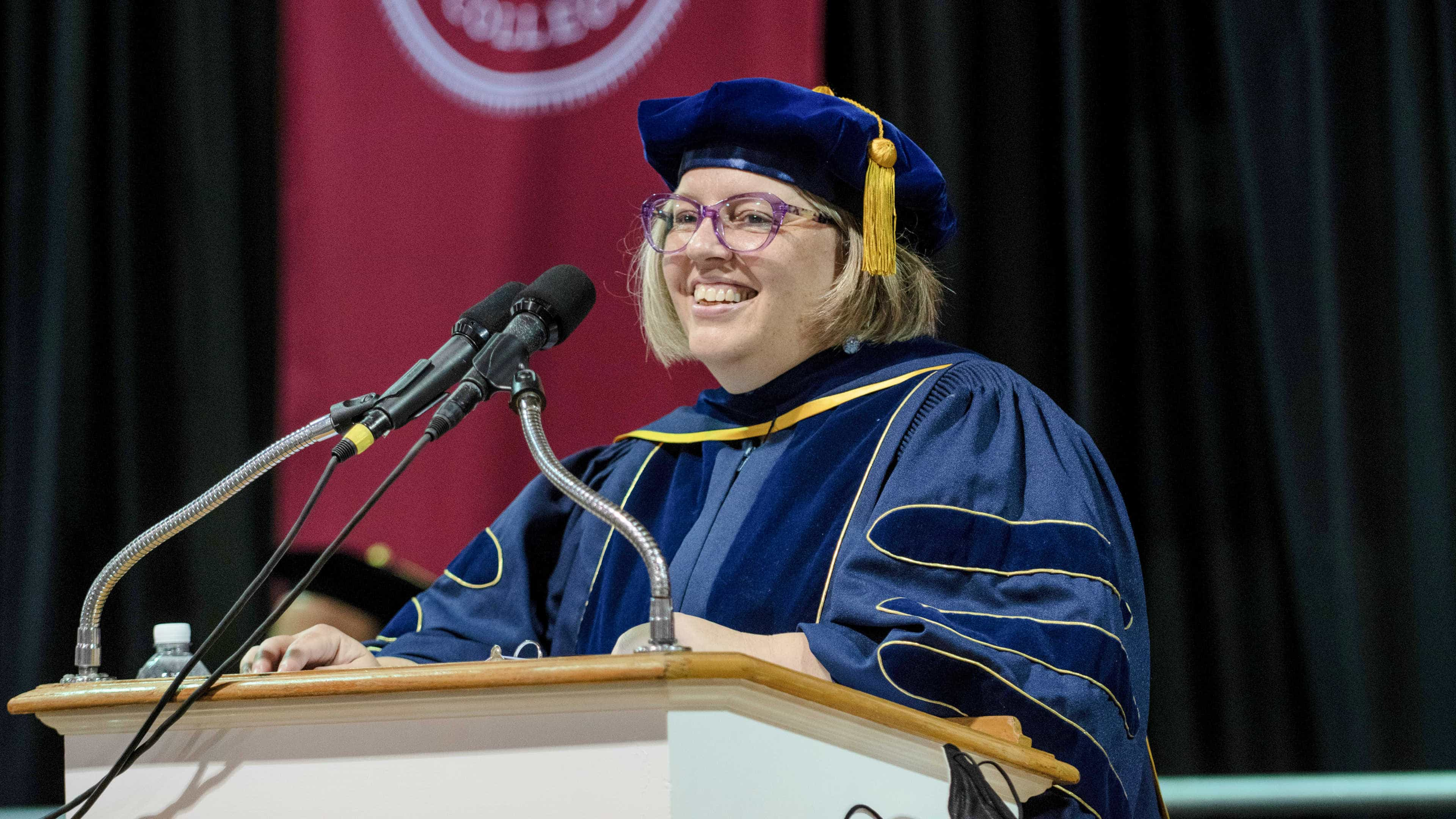 Provost Maria Rosales speaks from the podium at Commencement.